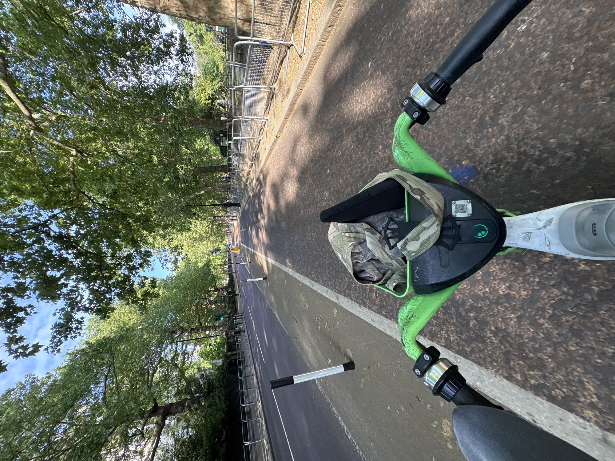Morning e-scooter ride captured on tree-lined London street