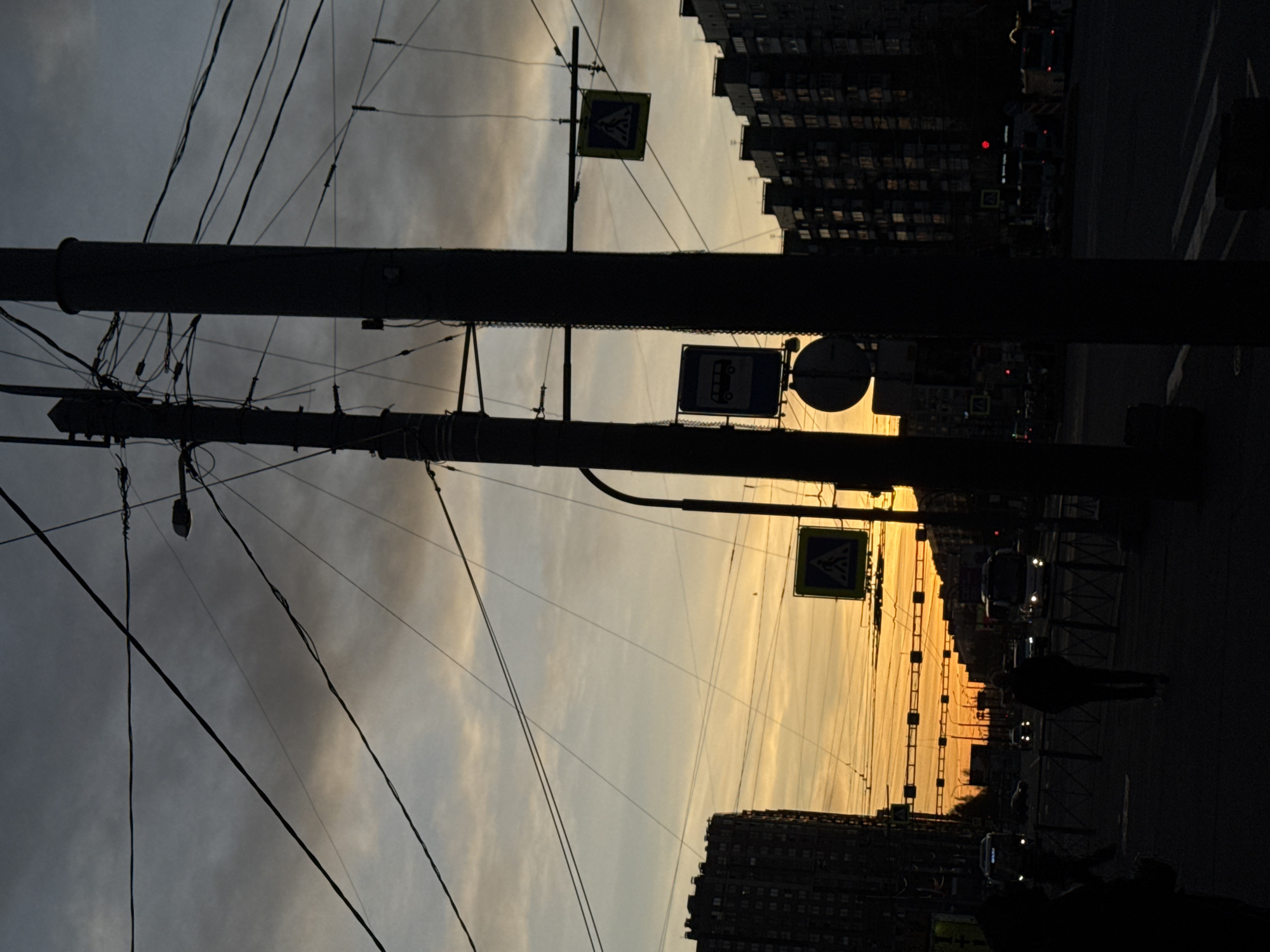 Saint Petersburg sunset creates dramatic urban silhouettes, contrail spotted