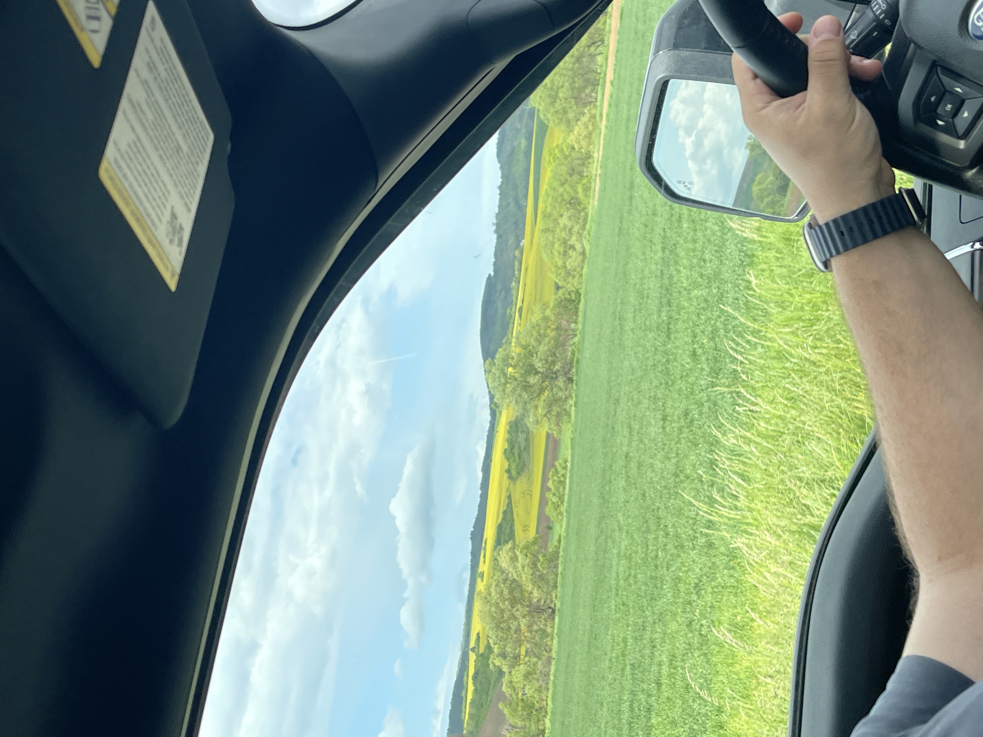 Driver travels through green countryside near Yardzhilovtsi, Bulgaria