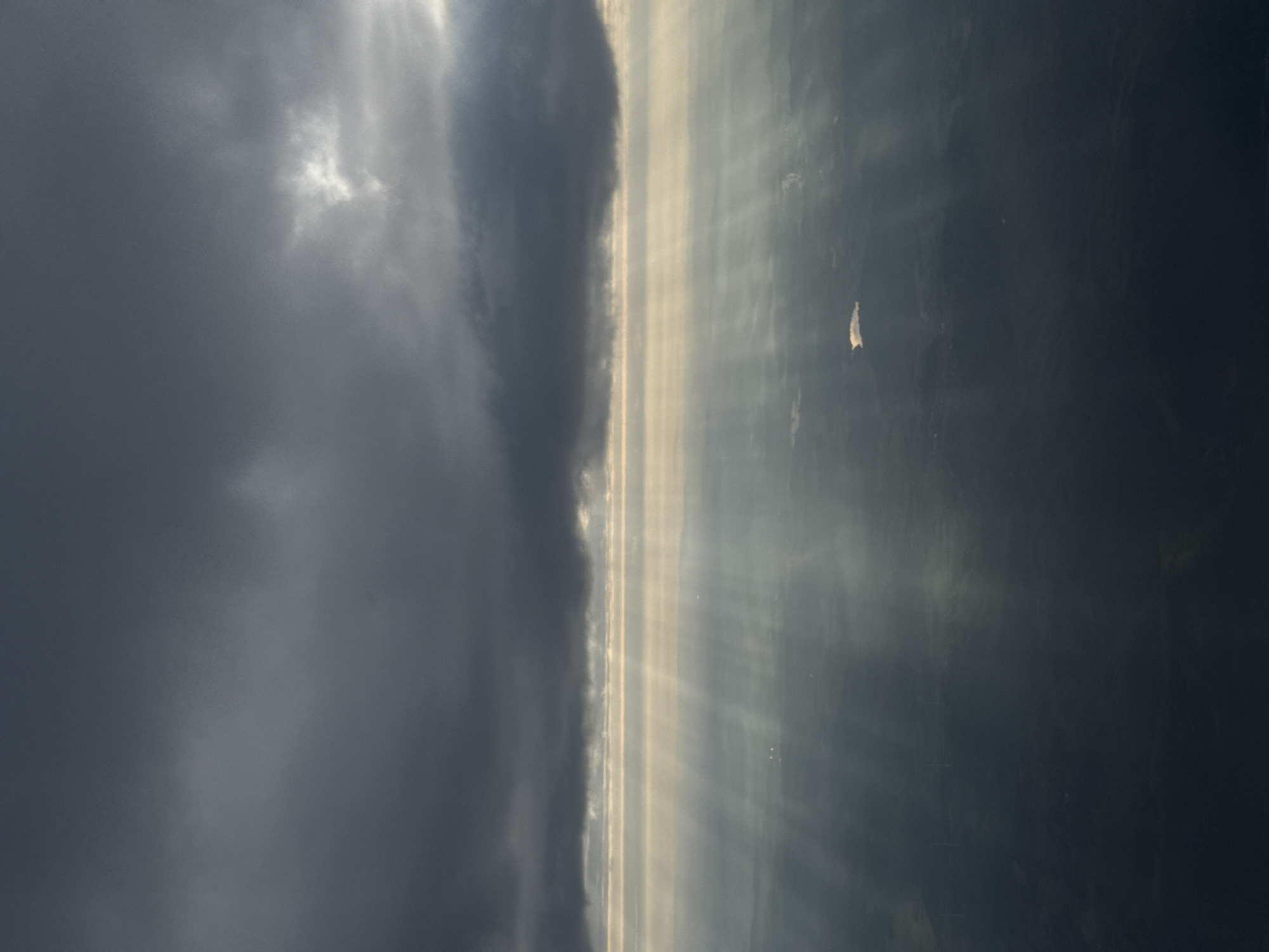 Morning sunbeams pierce heavy clouds over Freudenburg, Germany