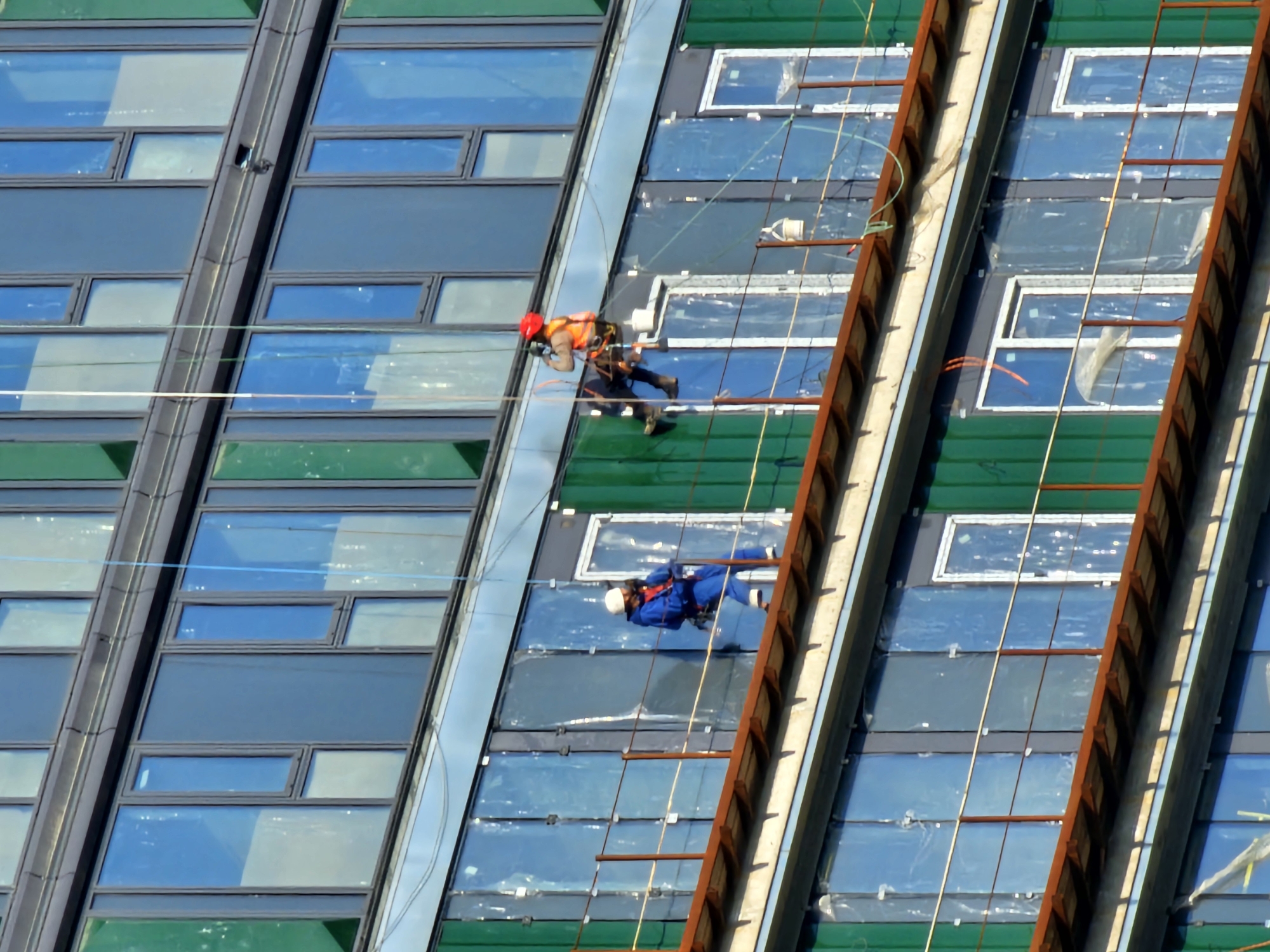 Workers rappel down building facade in Khimki, Russia