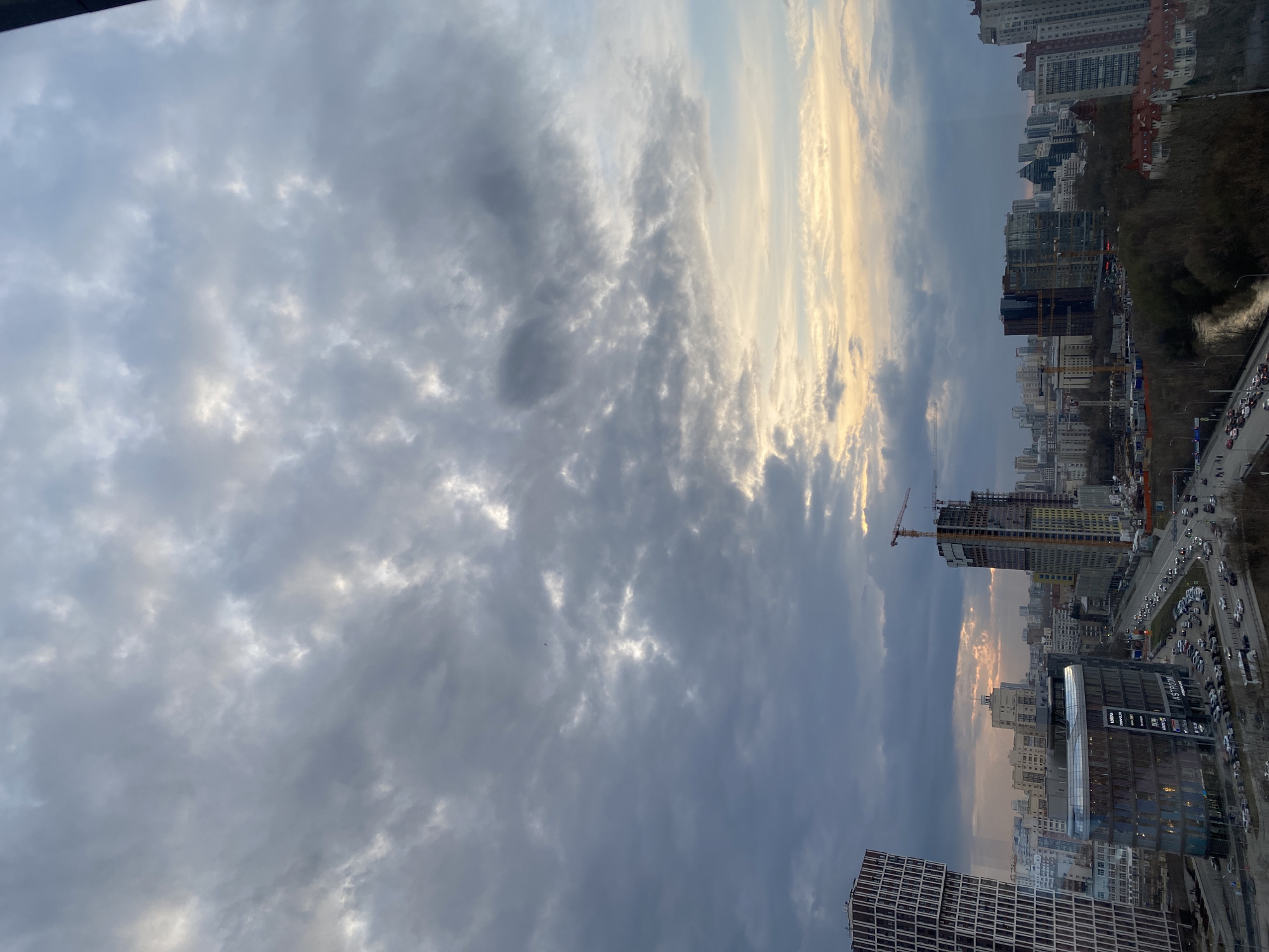 Window cleaner works on Yekaterinburg high-rise amid construction activity