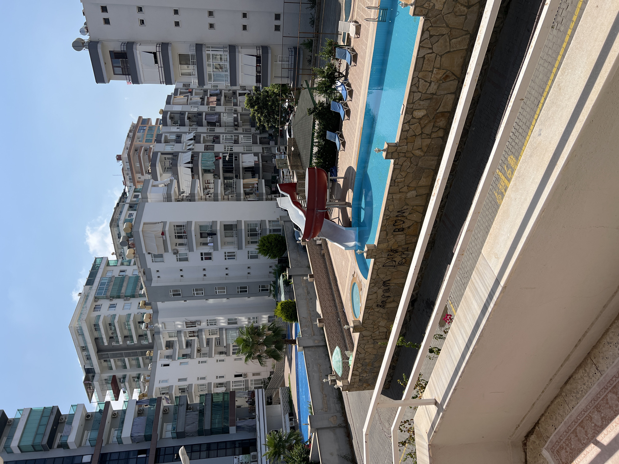 Sunny morning at an Alanya residential complex with blooming bougainvillea