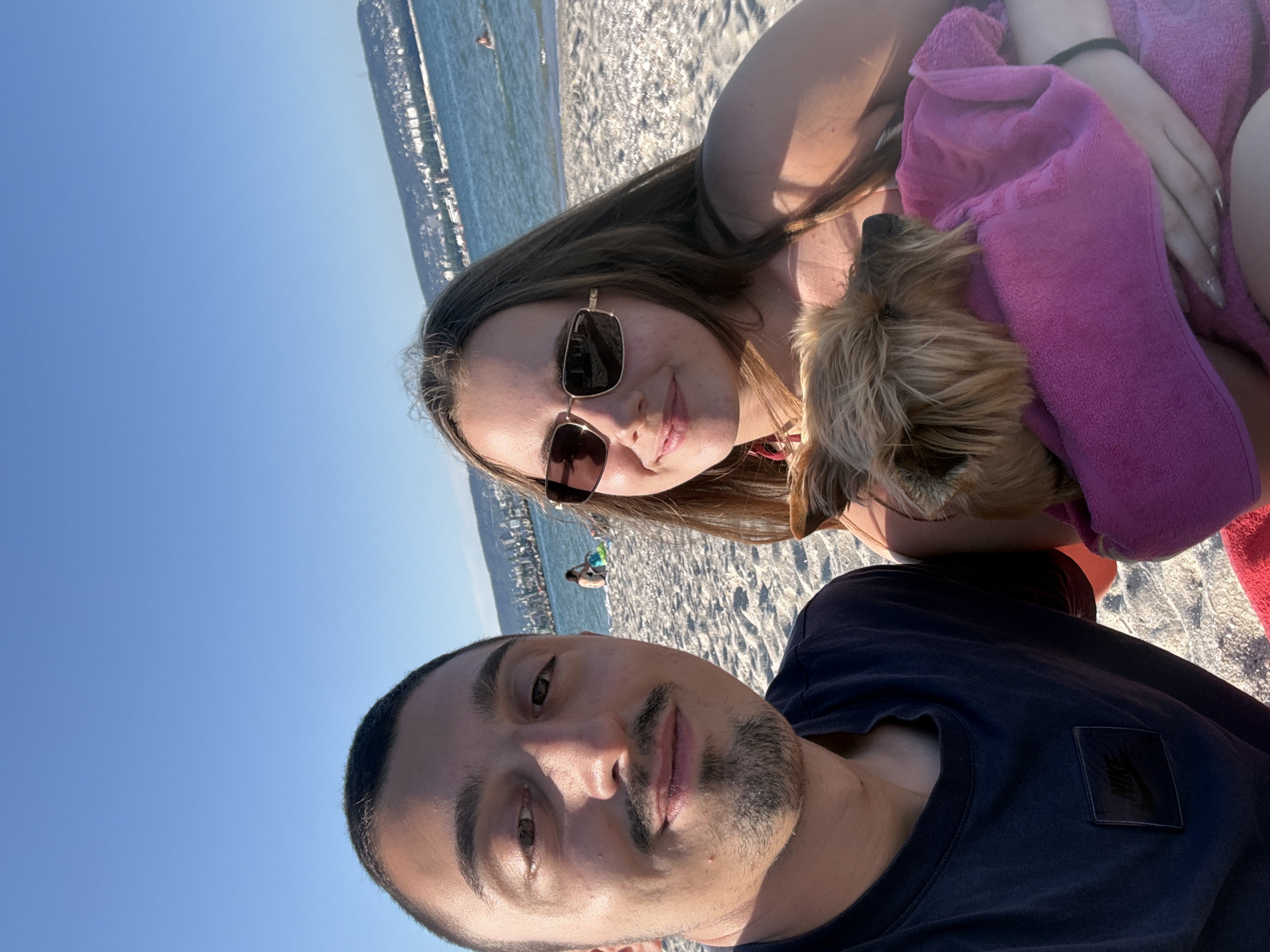 Couple enjoys beach day with dog in Varna, Bulgaria
