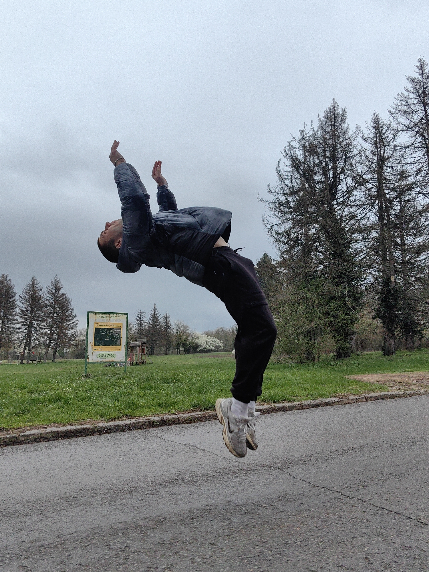Person performs backflip on bridge over canal in Shumen
