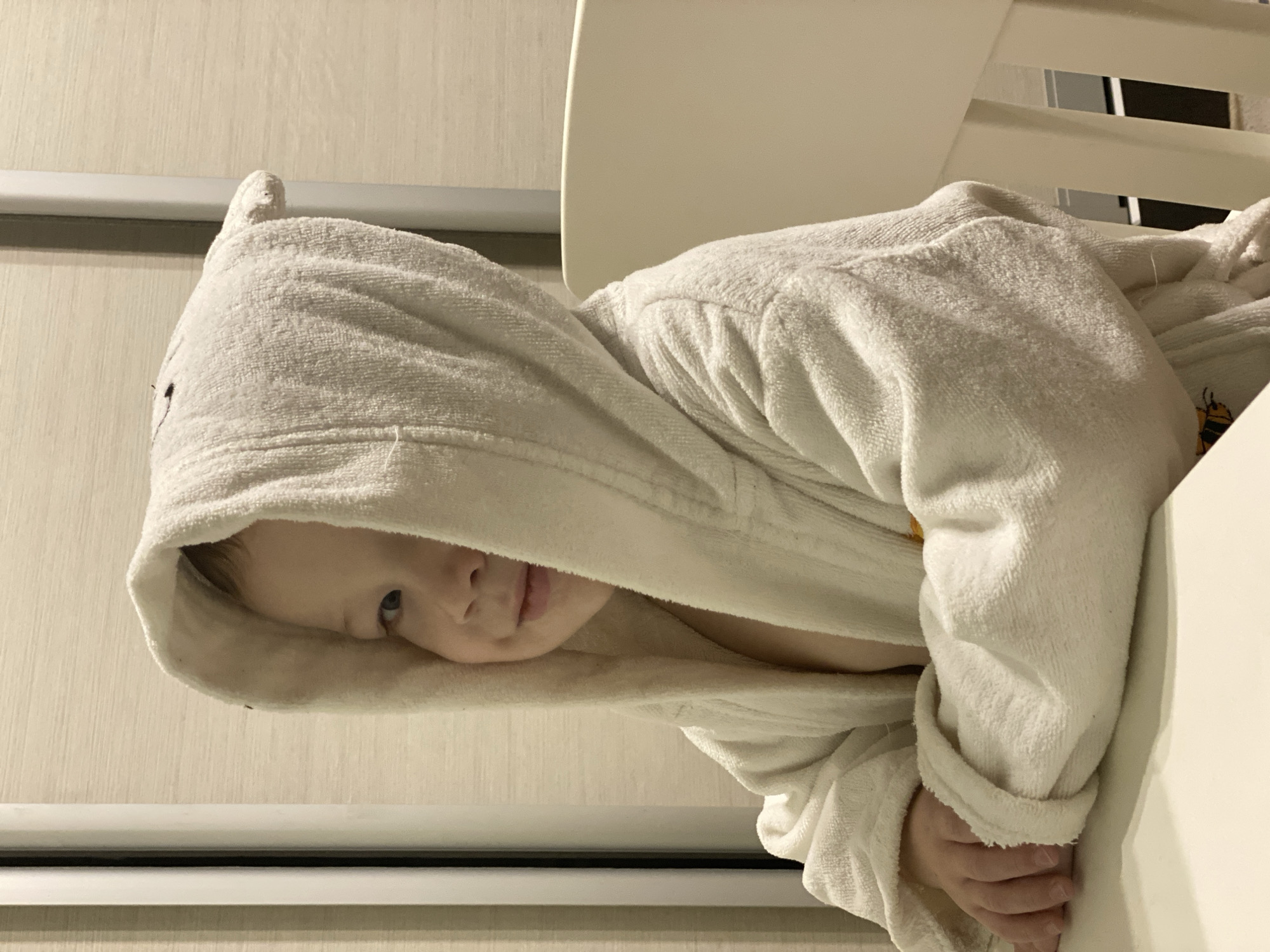 Child in white bathrobe spotted indoors in Sochi
