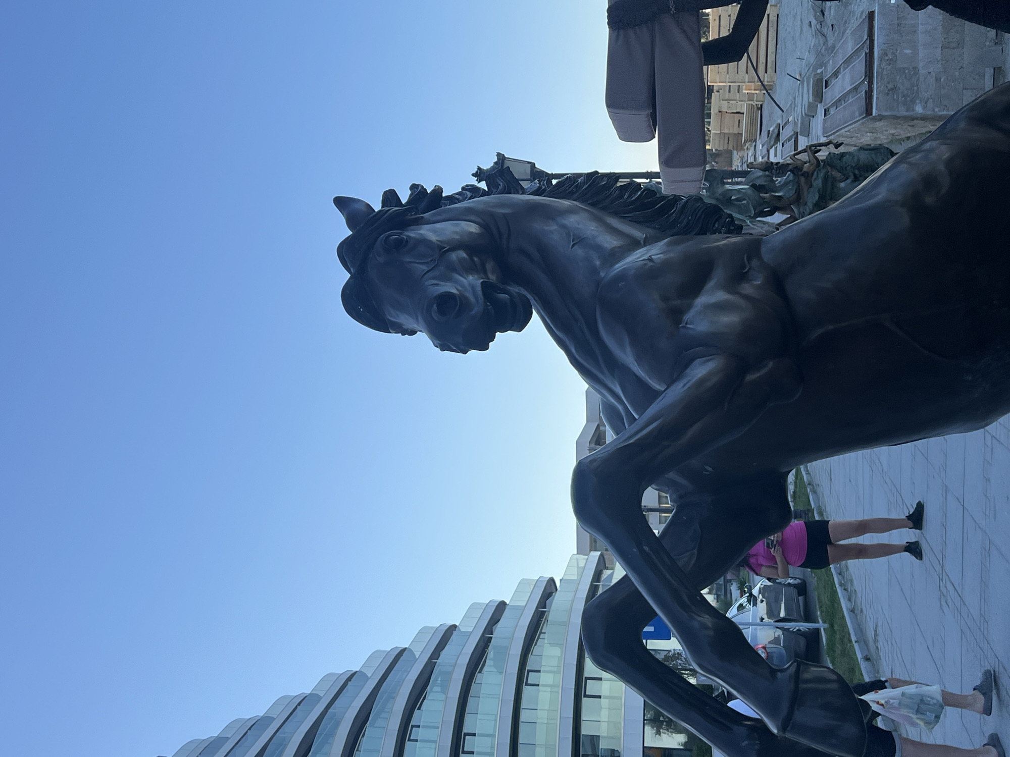 Bronze statues and modern architecture along Năvodari's waterfront promenade