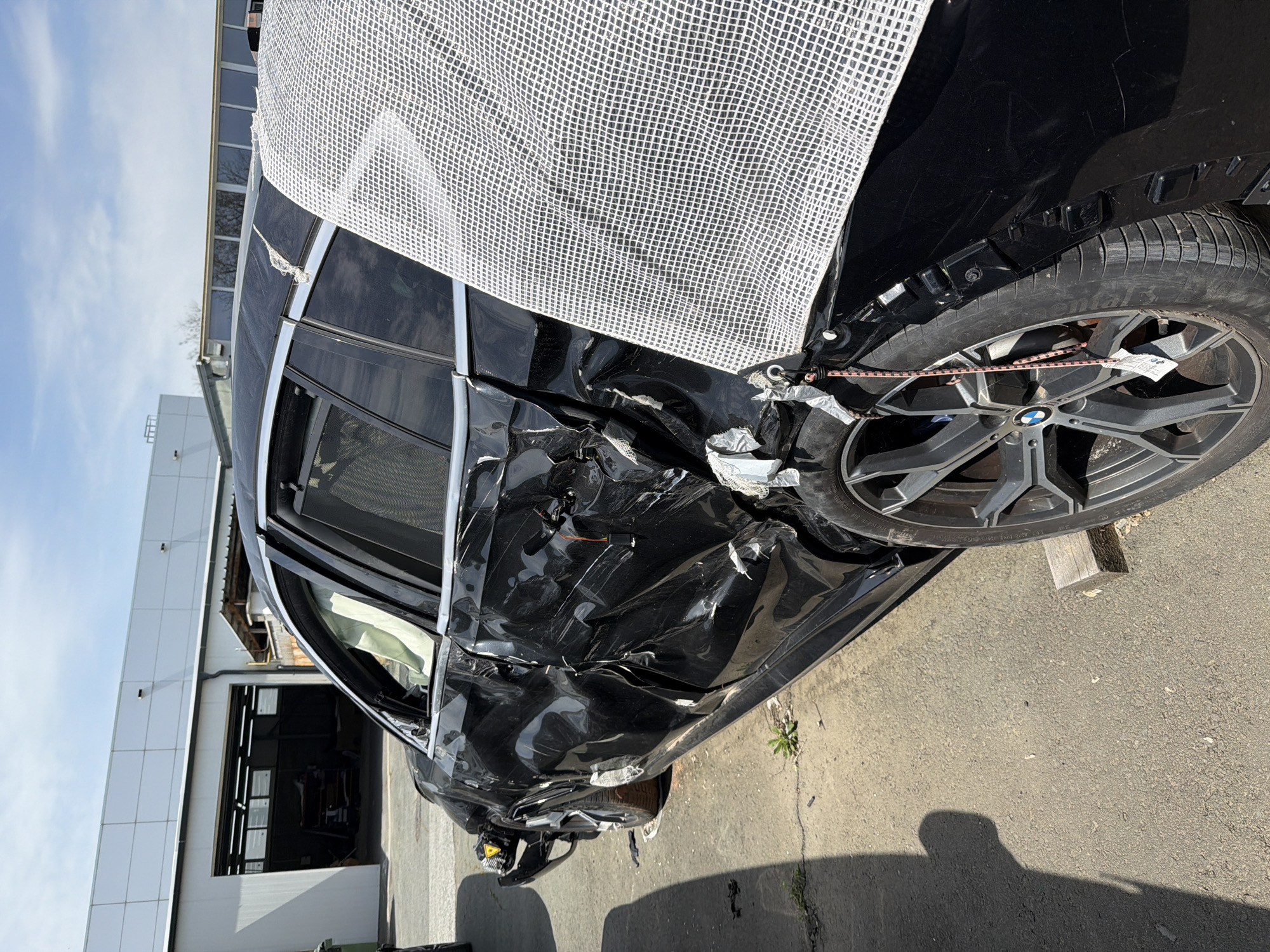 Damaged BMW and Toyota Supra documented at automotive workshop