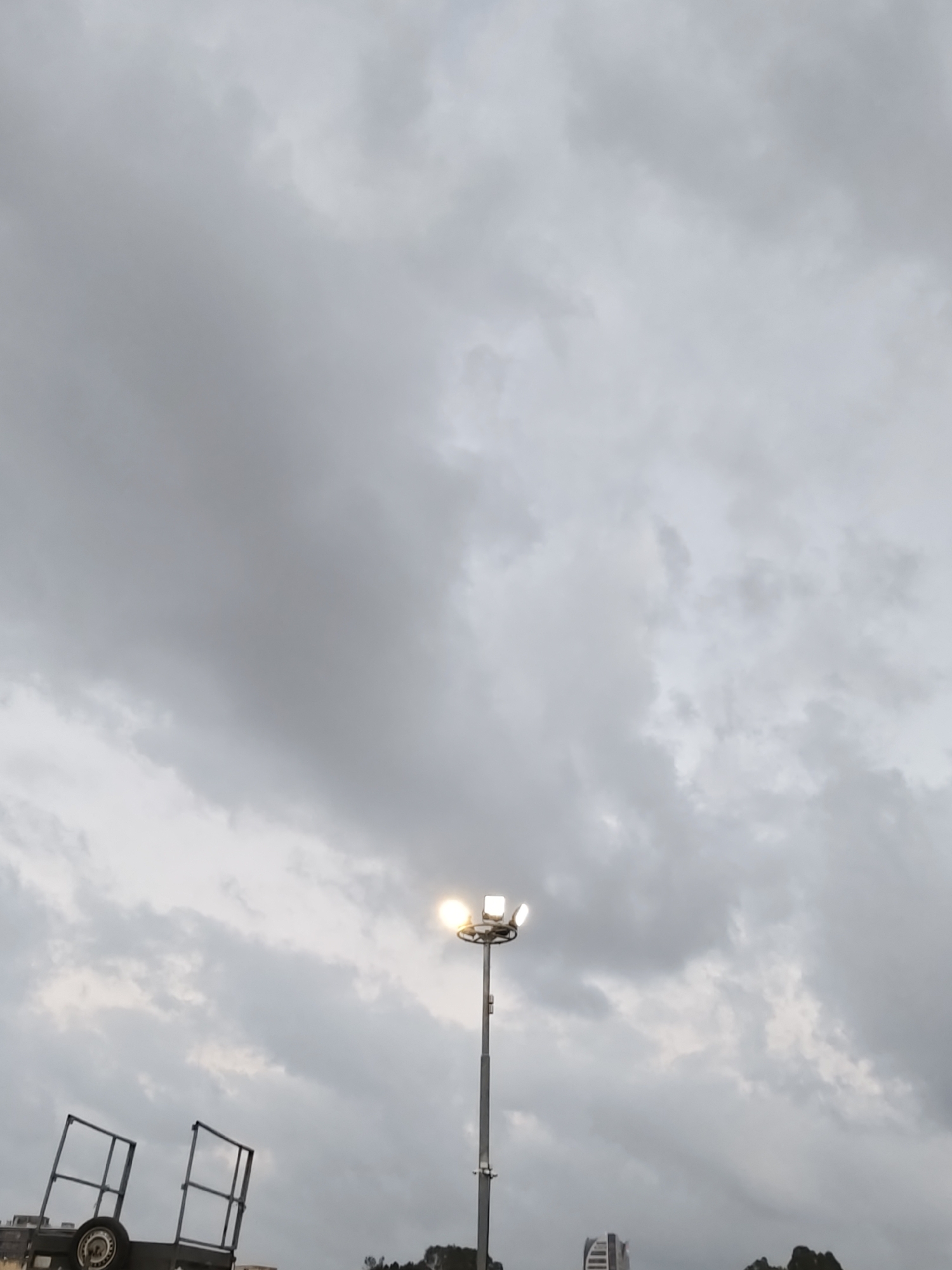 Outdoor lot in Petah Tikva, cloudy skies and a crescent moon