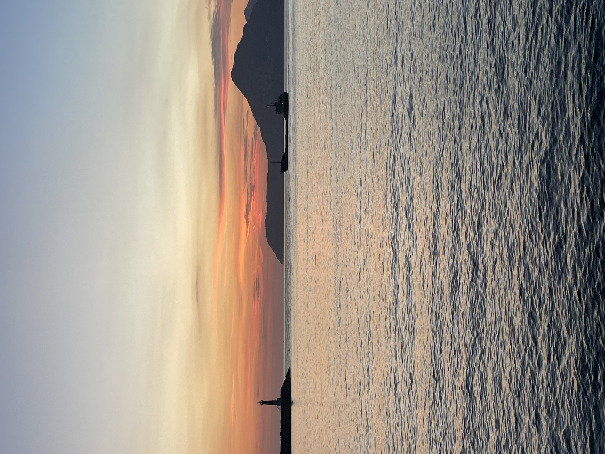Adriatic sunset in Bar, Montenegro, lighthouse and mountains in view