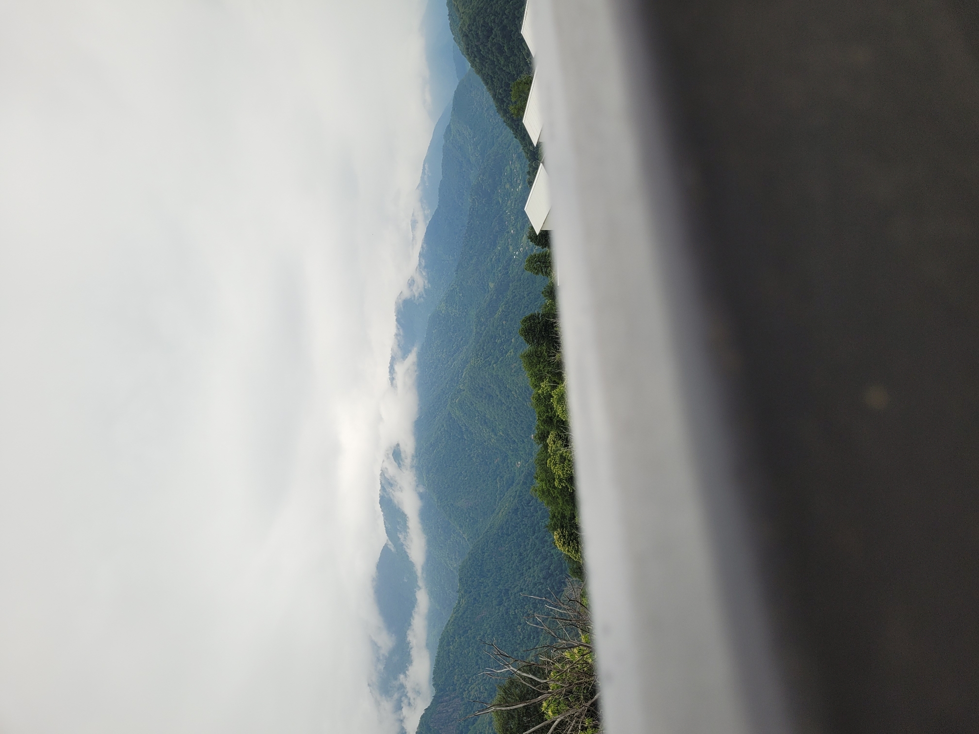 Construction and cloud-covered hills in rural Milisi, Georgia