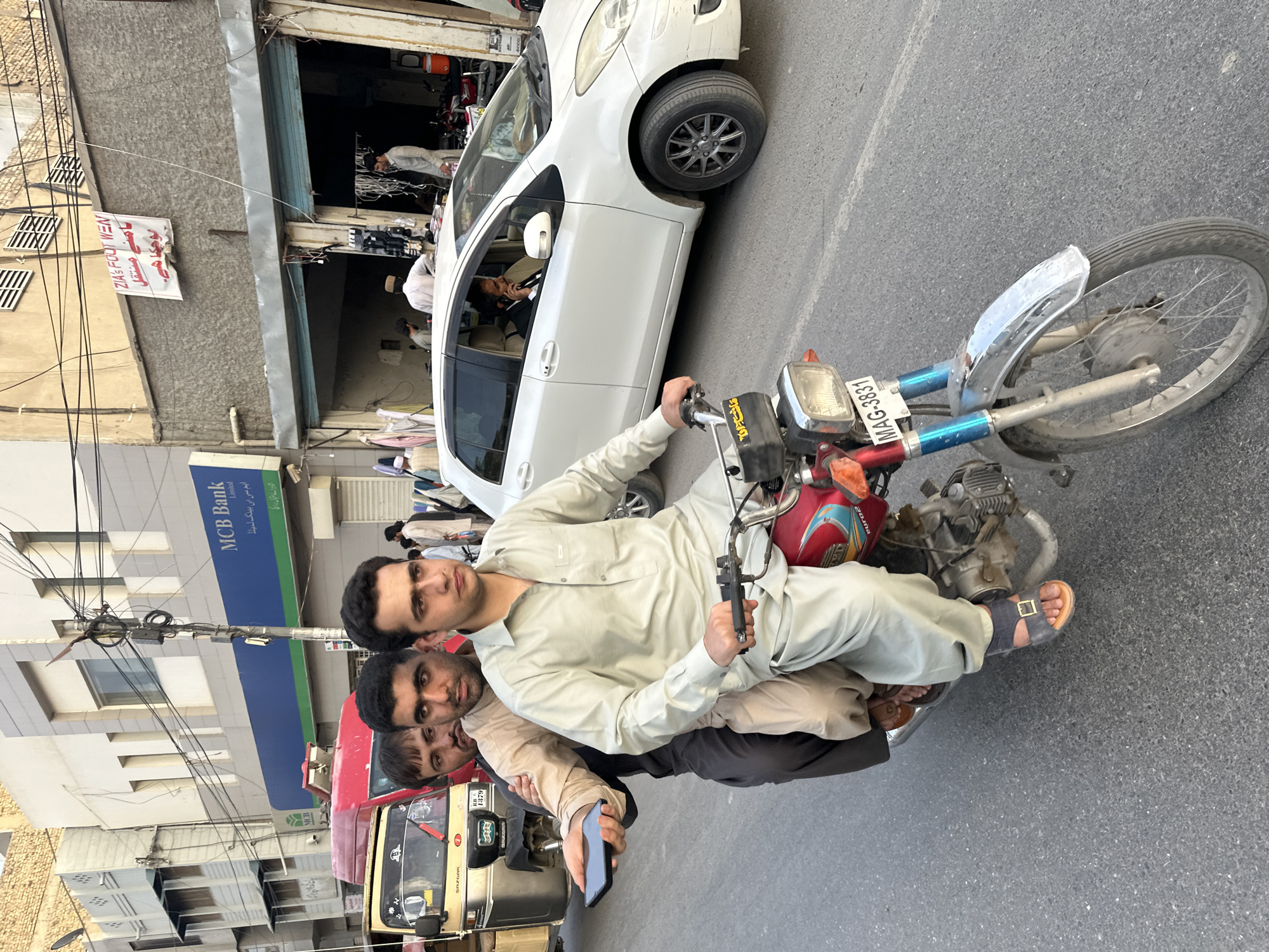 Three men share motorcycle ride in Quetta City