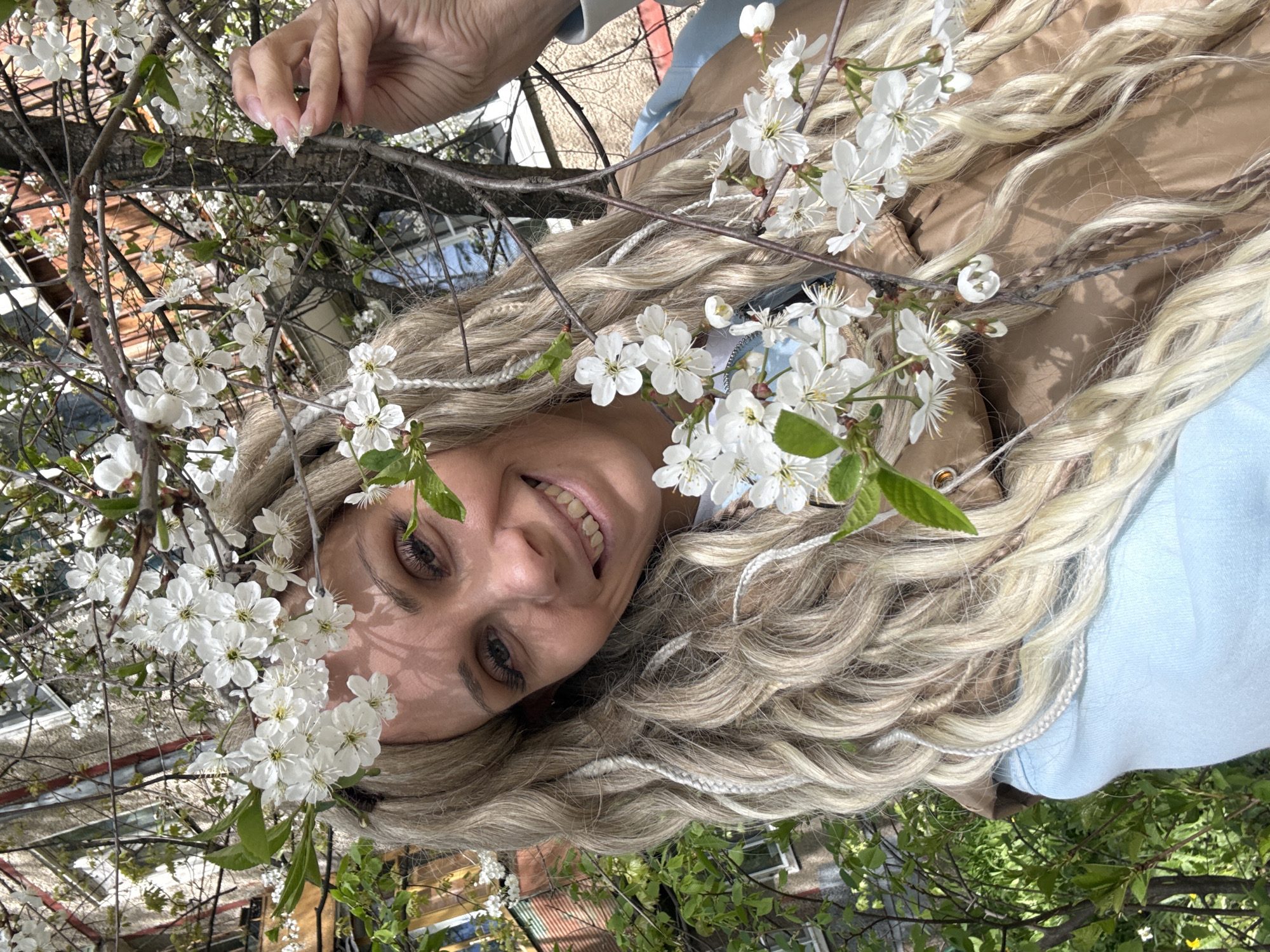 Woman rests among white flowers in Yaroslavl park
