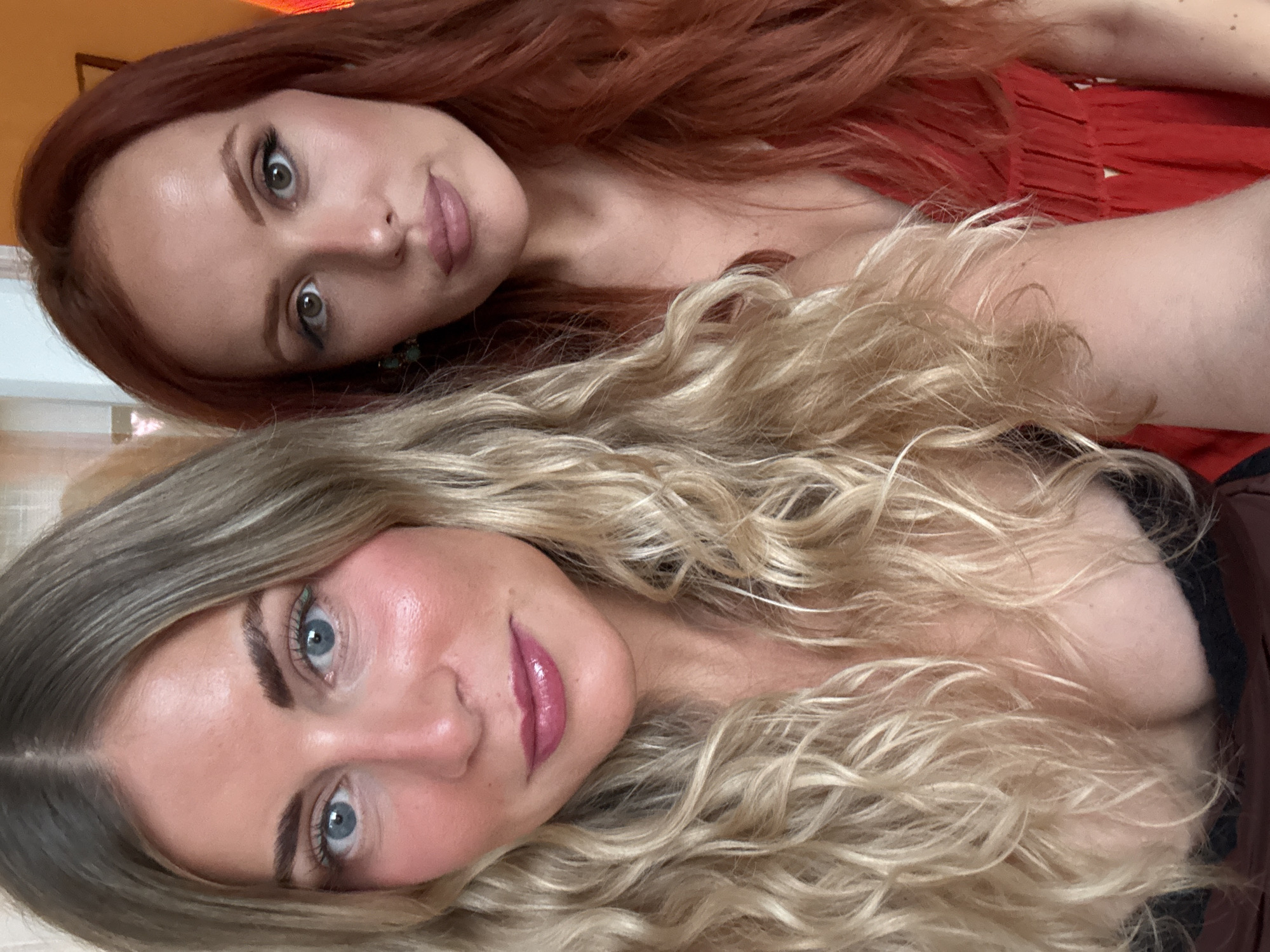 Two women take selfies together indoors in Paris
