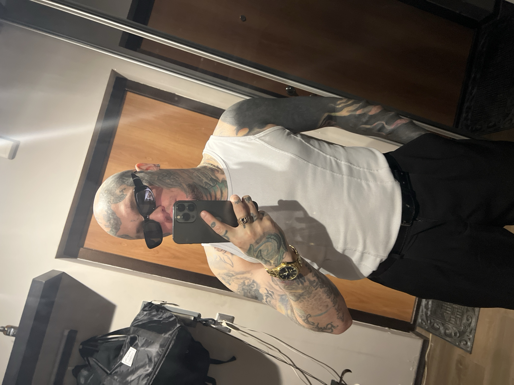 Tattooed individual takes mirror selfie in Kudrovo, Russia