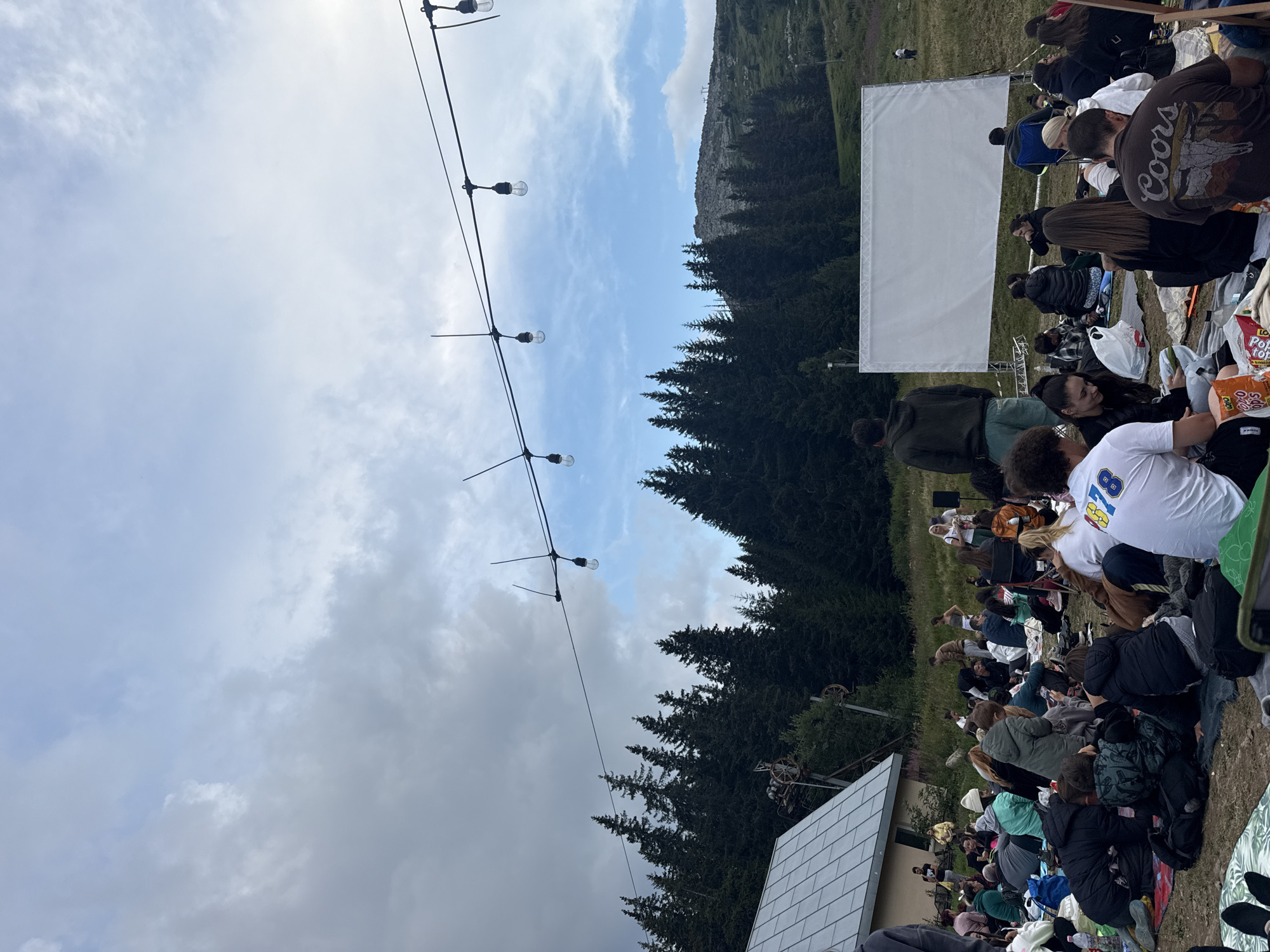 Outdoor film screening on a forested hillside in Bistritsa