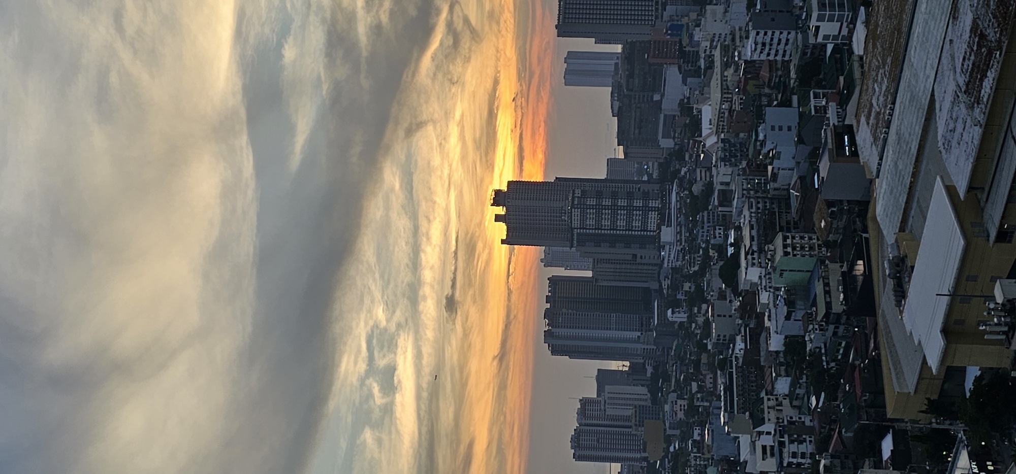 Makati skyline, elevated highway, and shifting morning skies