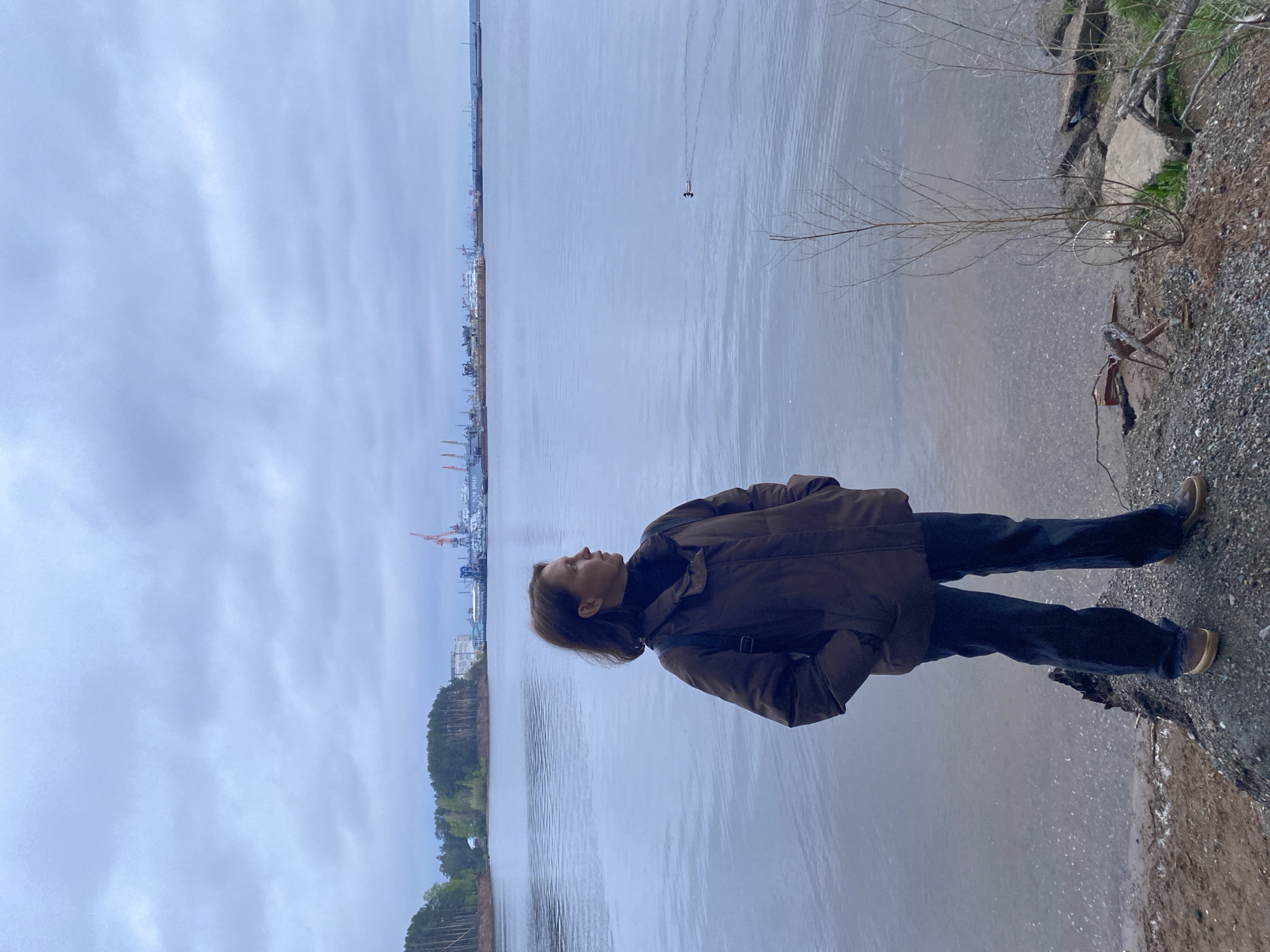 Person enjoys quiet riverside moments in Chaikovsky, Russia