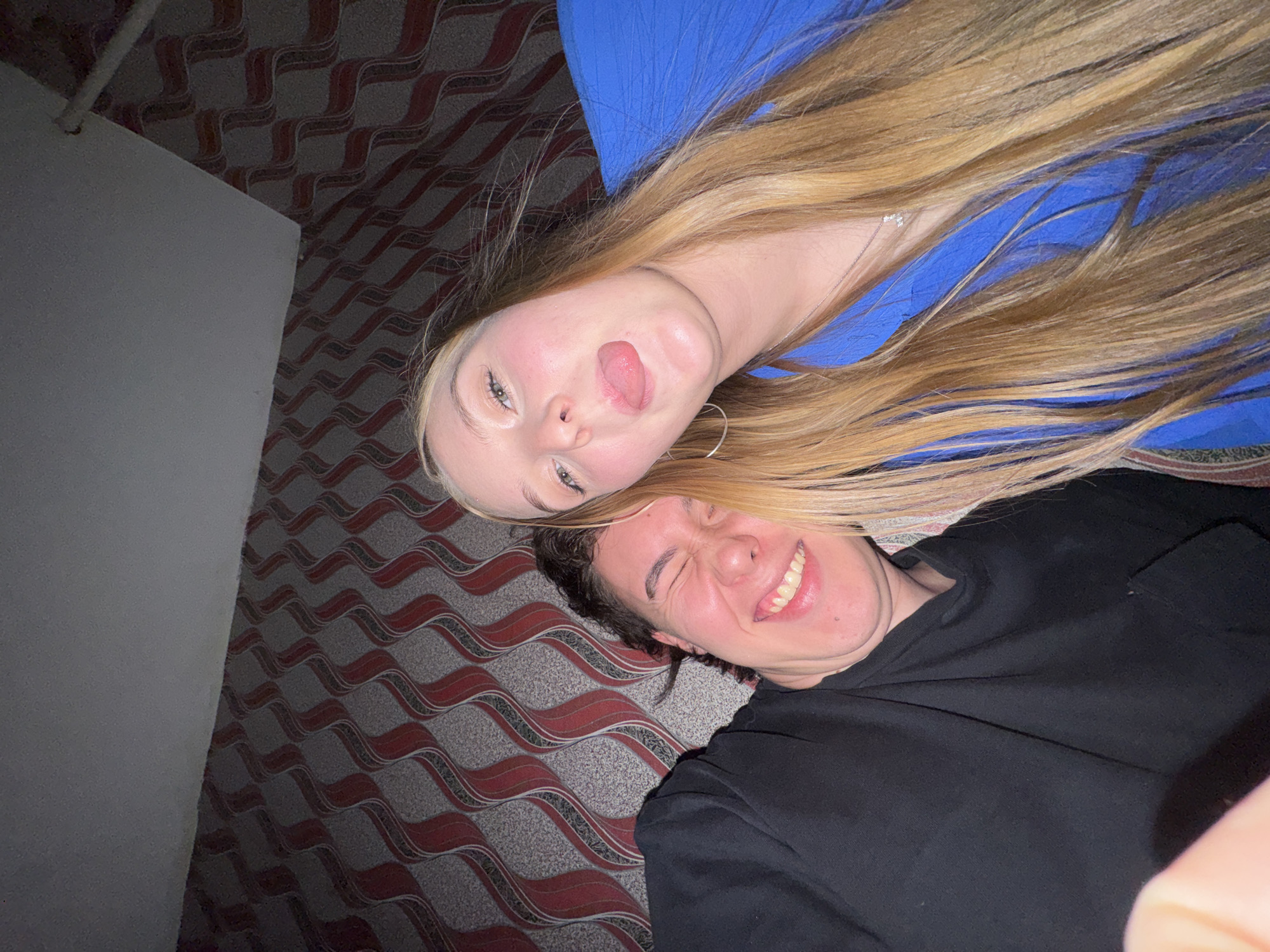 Young couple takes playful selfies in Perm apartment