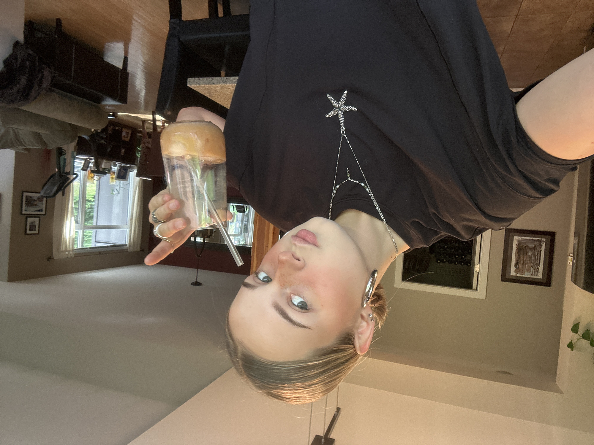 Person enjoys beverage in Whistler wearing starfish brooch