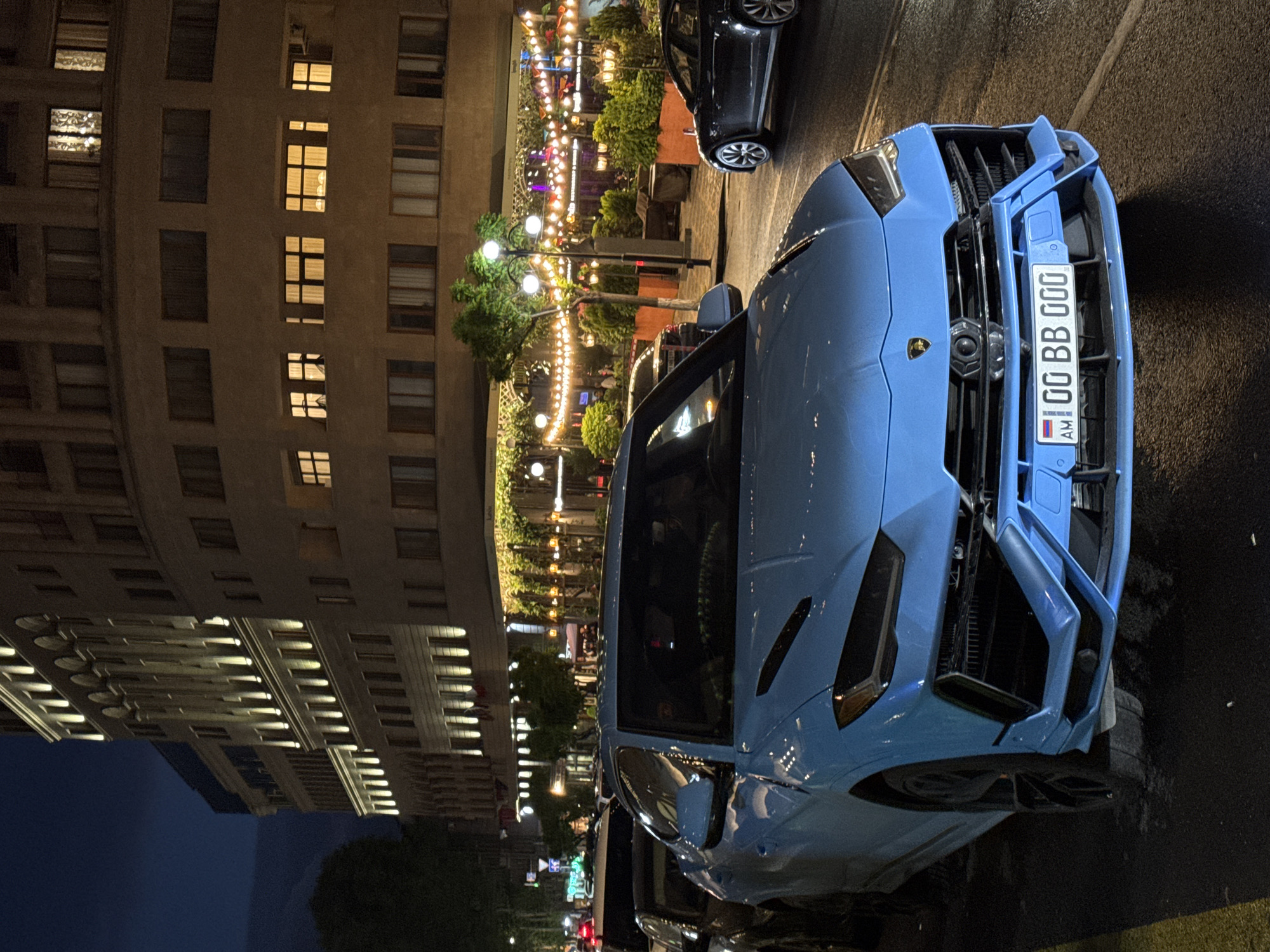 Luxury car draws attention in downtown Yerevan evening scenes