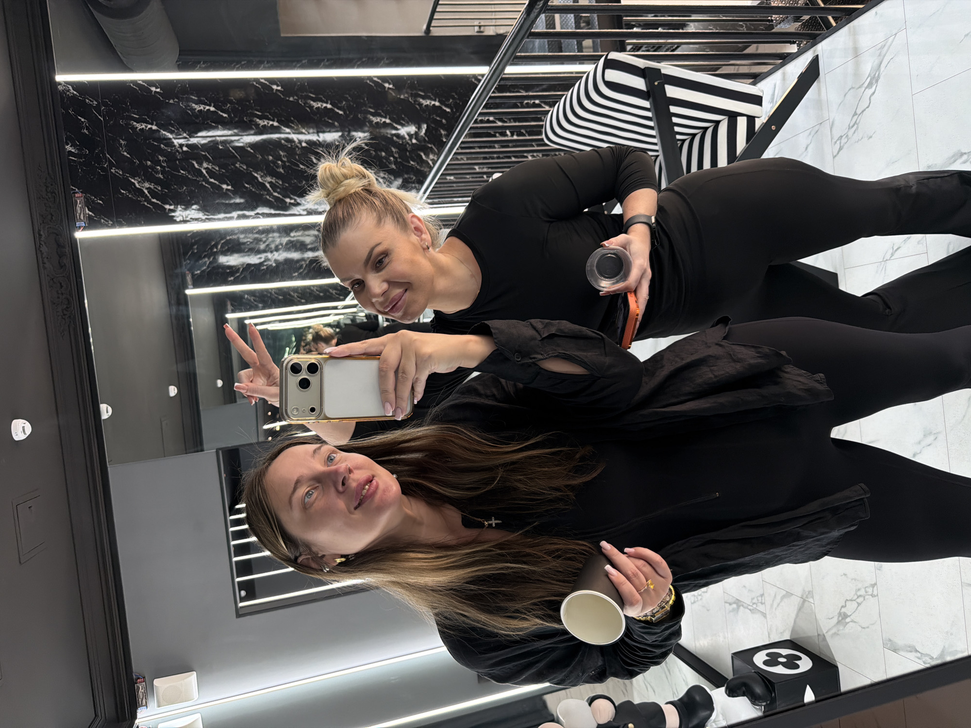 Women take selfies at boutique in Shcherbinka, Russia