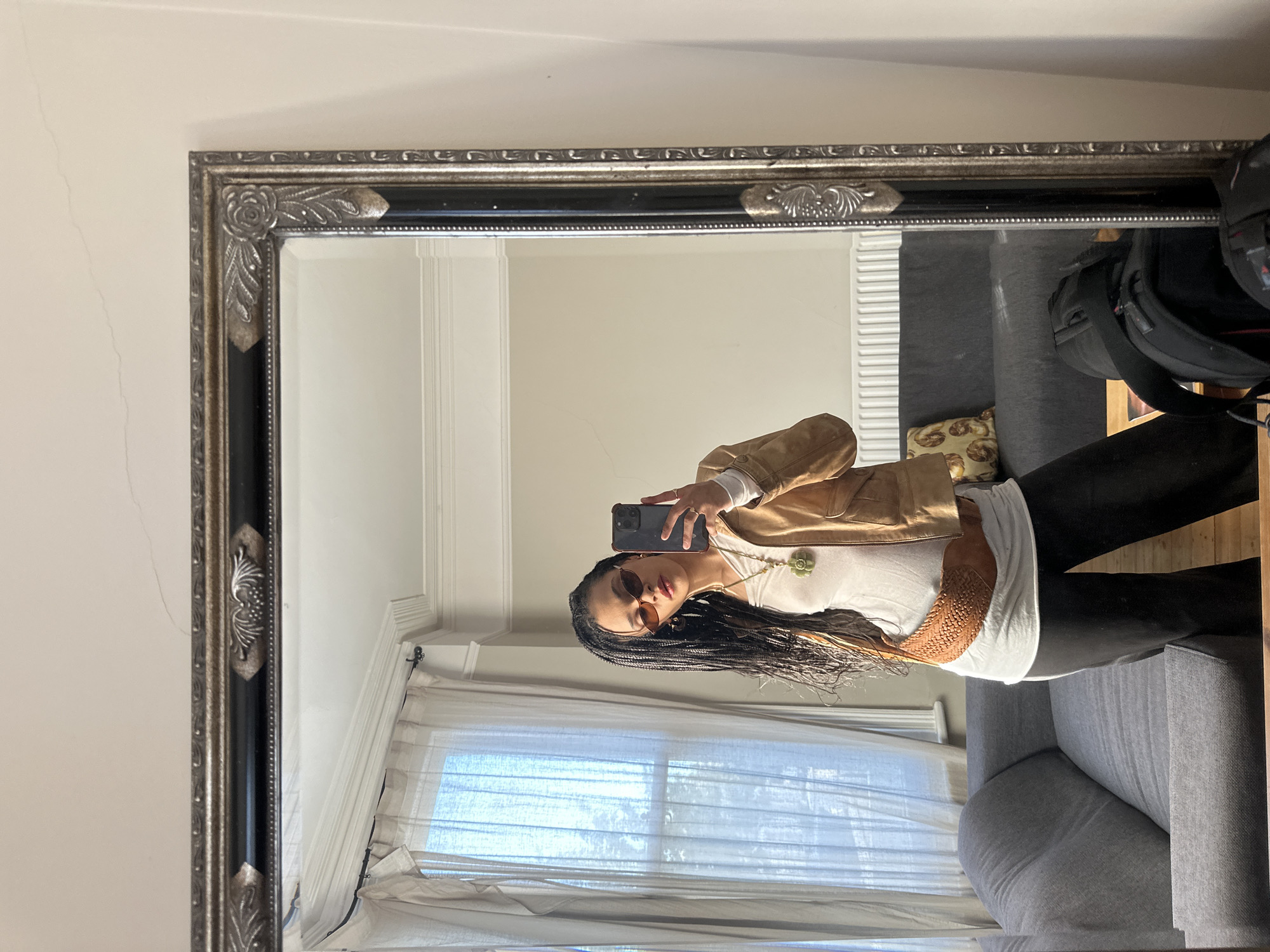 Woman takes mirror selfie in London living space