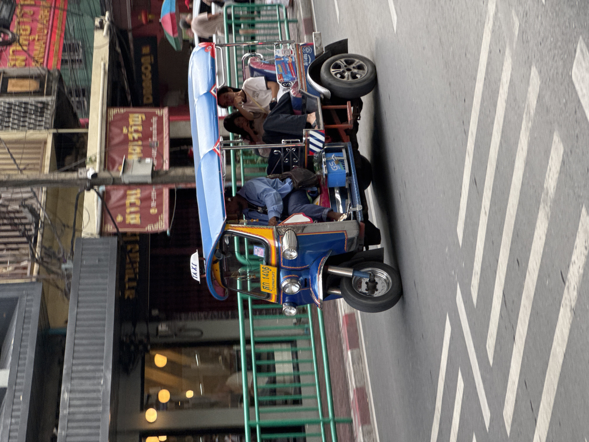 Tuk-tuks and street food on a busy Bangkok morning