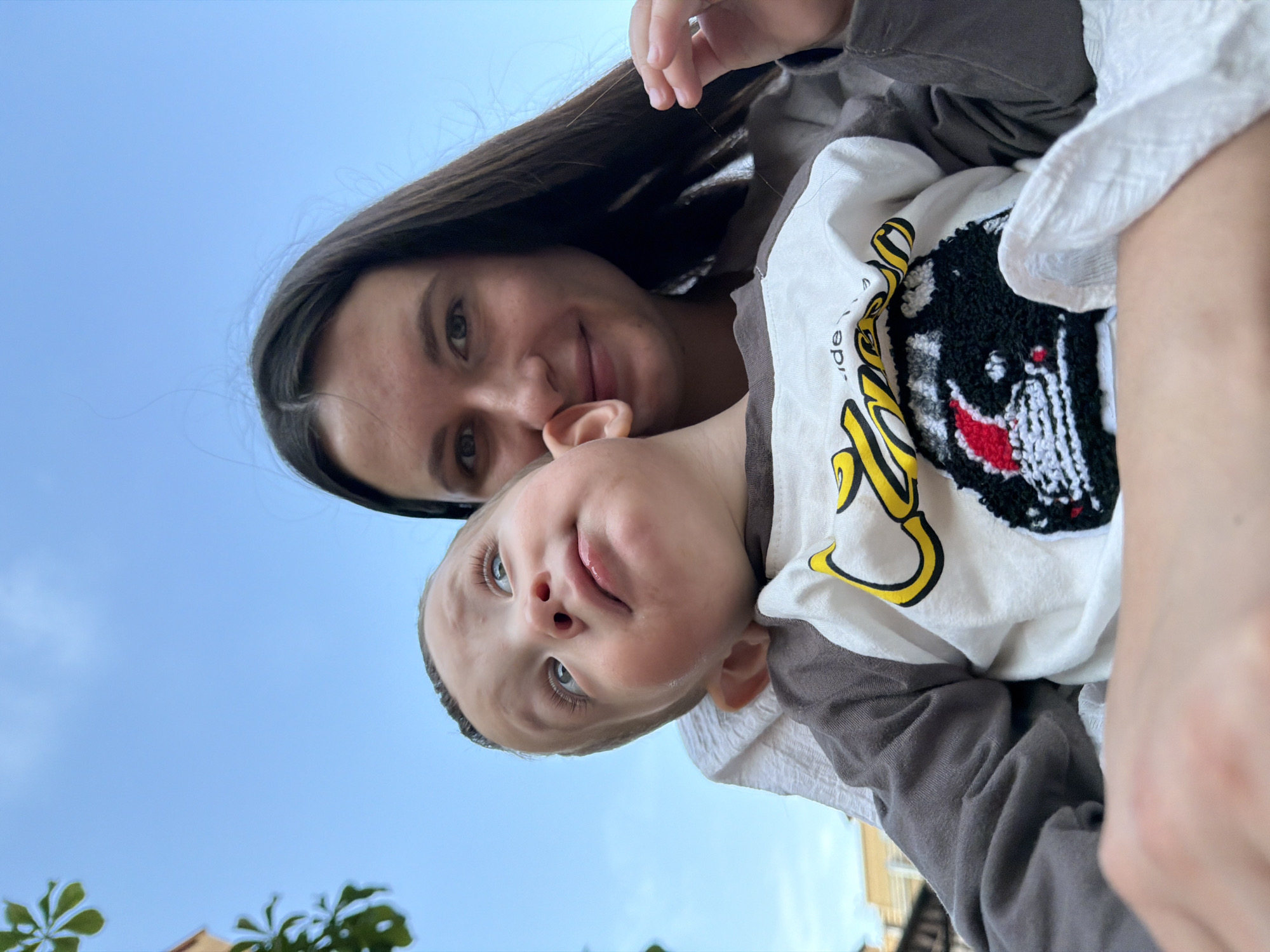 Children play at playground in Vniissok, woman with baby present