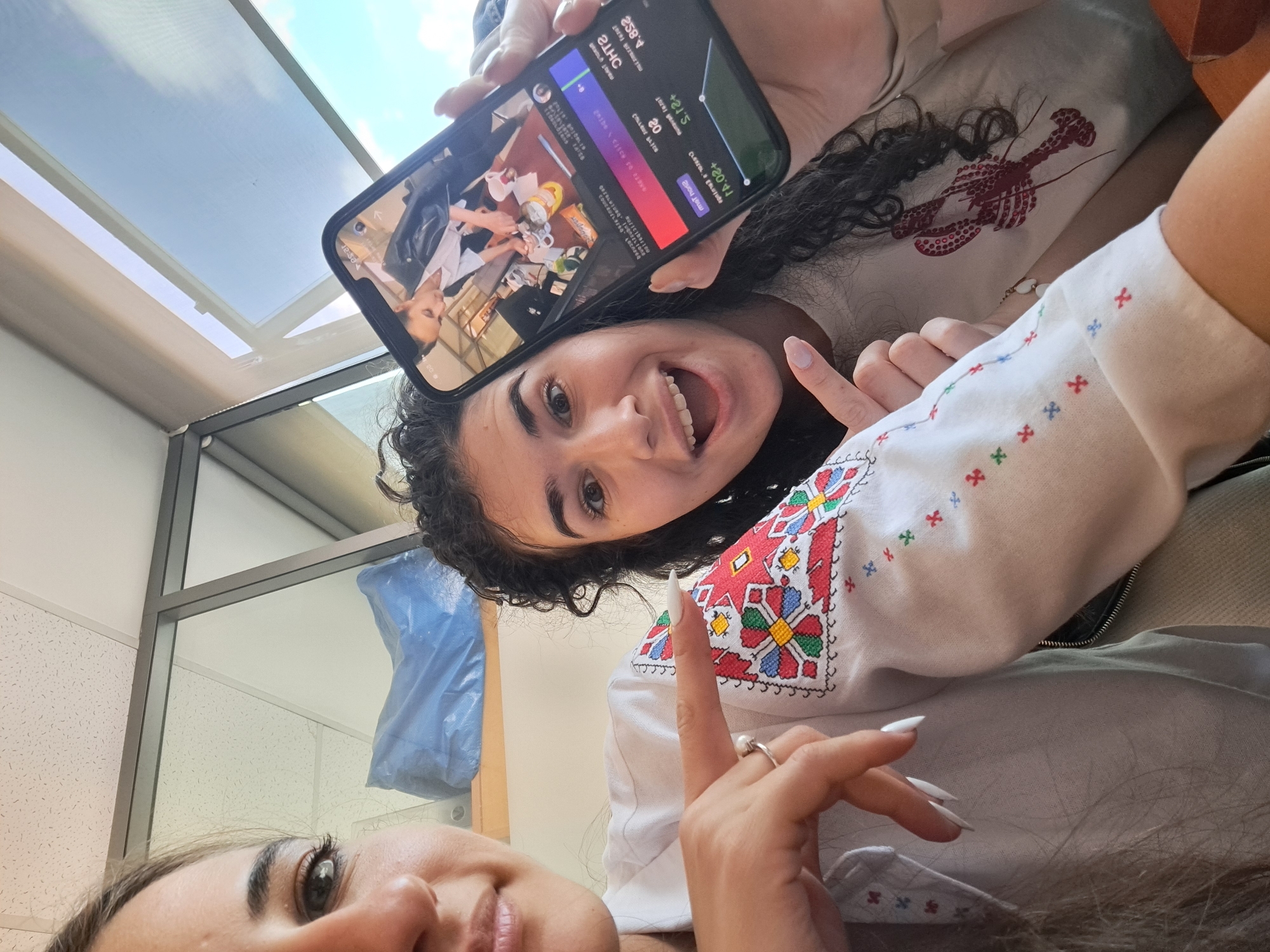 Two women share joyful moment in indoor selfie