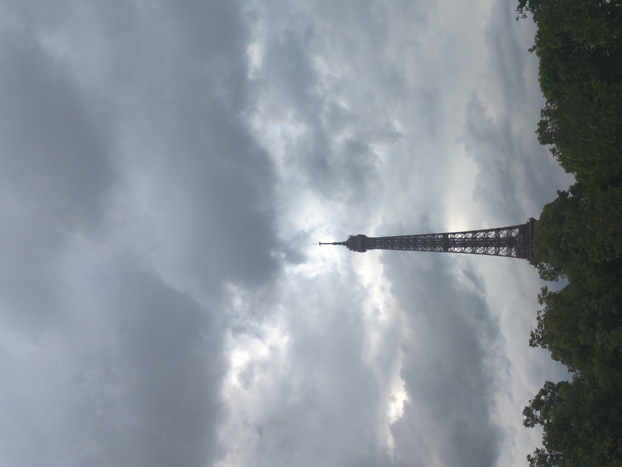 Eiffel Tower observed under cloudy Paris skies