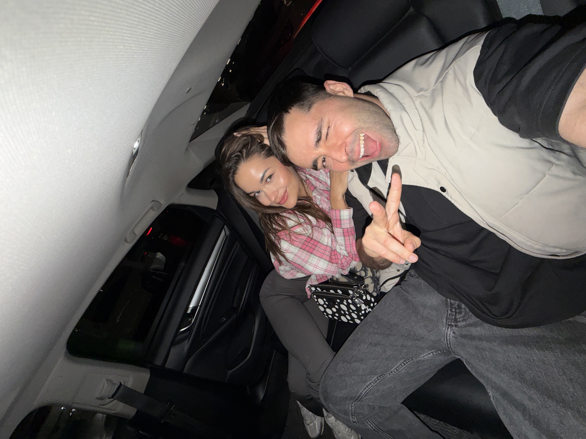 Man poses with peace sign in car photo, Langfang