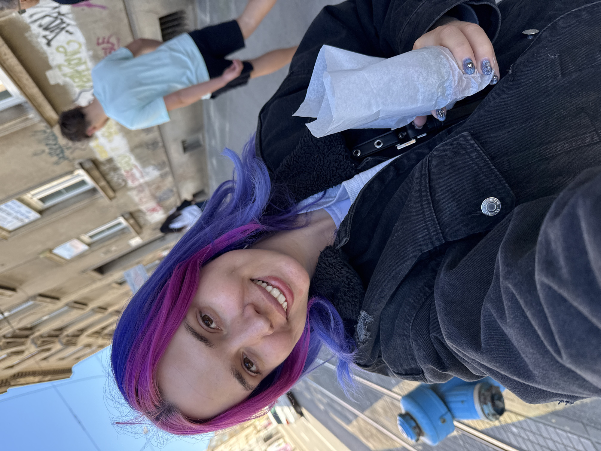 Purple-haired person photographed near Zagreb church on sunny morning