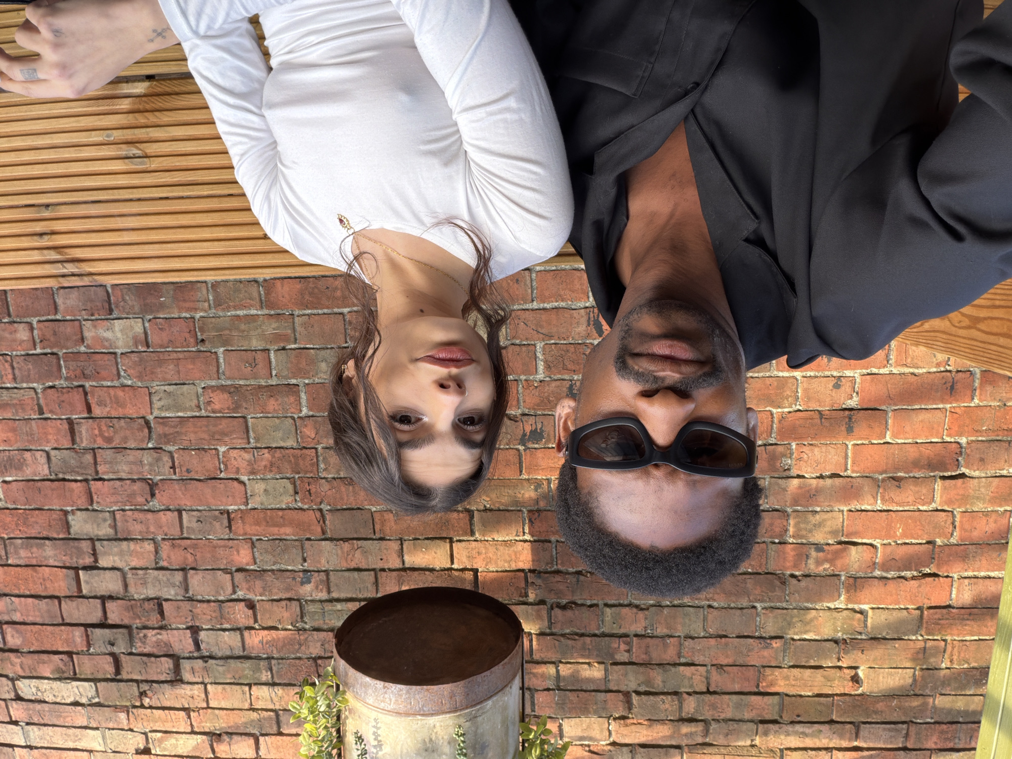 Two people photographed near brick wall in Folkestone