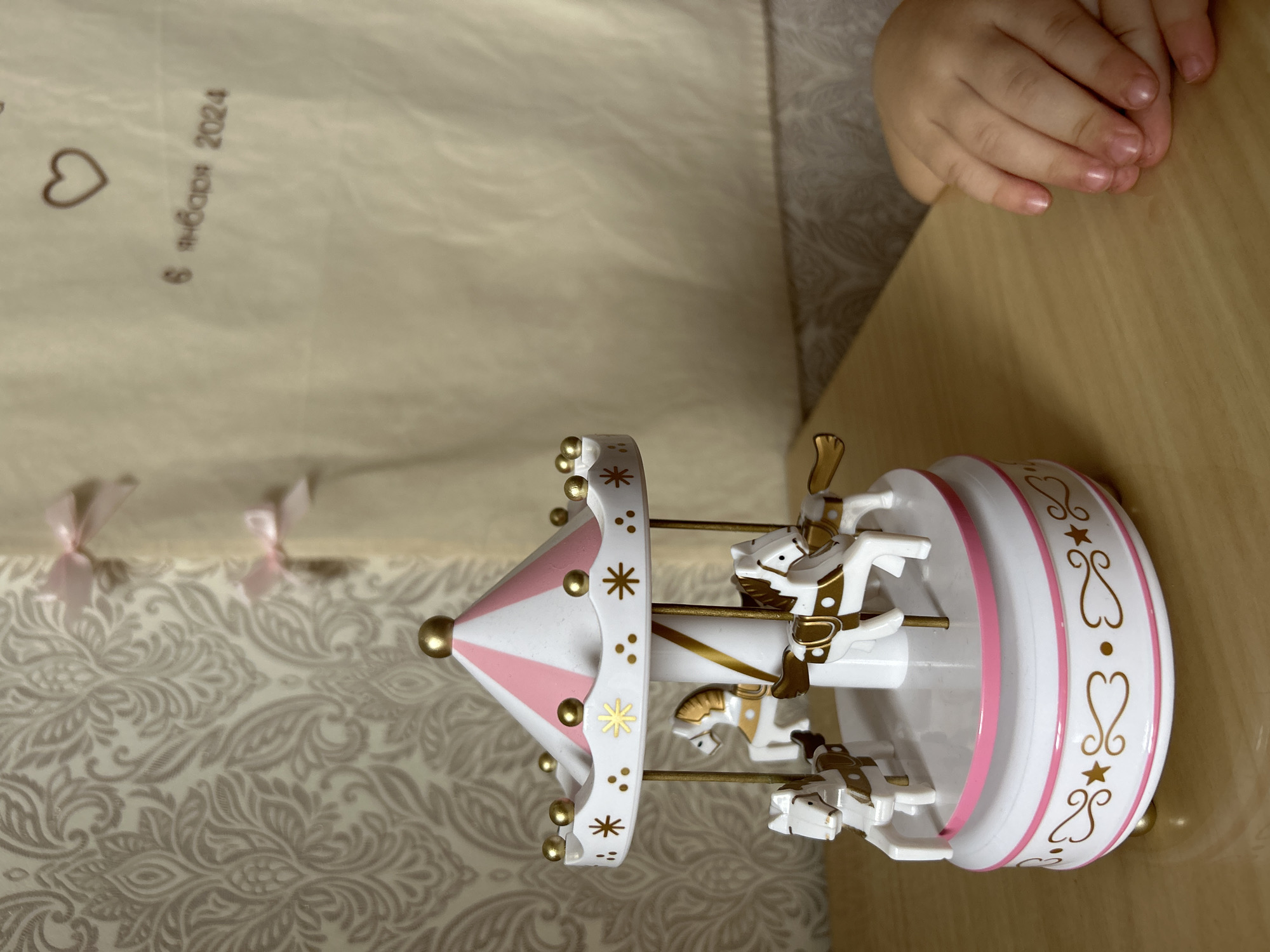 Child plays with carousel music box in Ufa