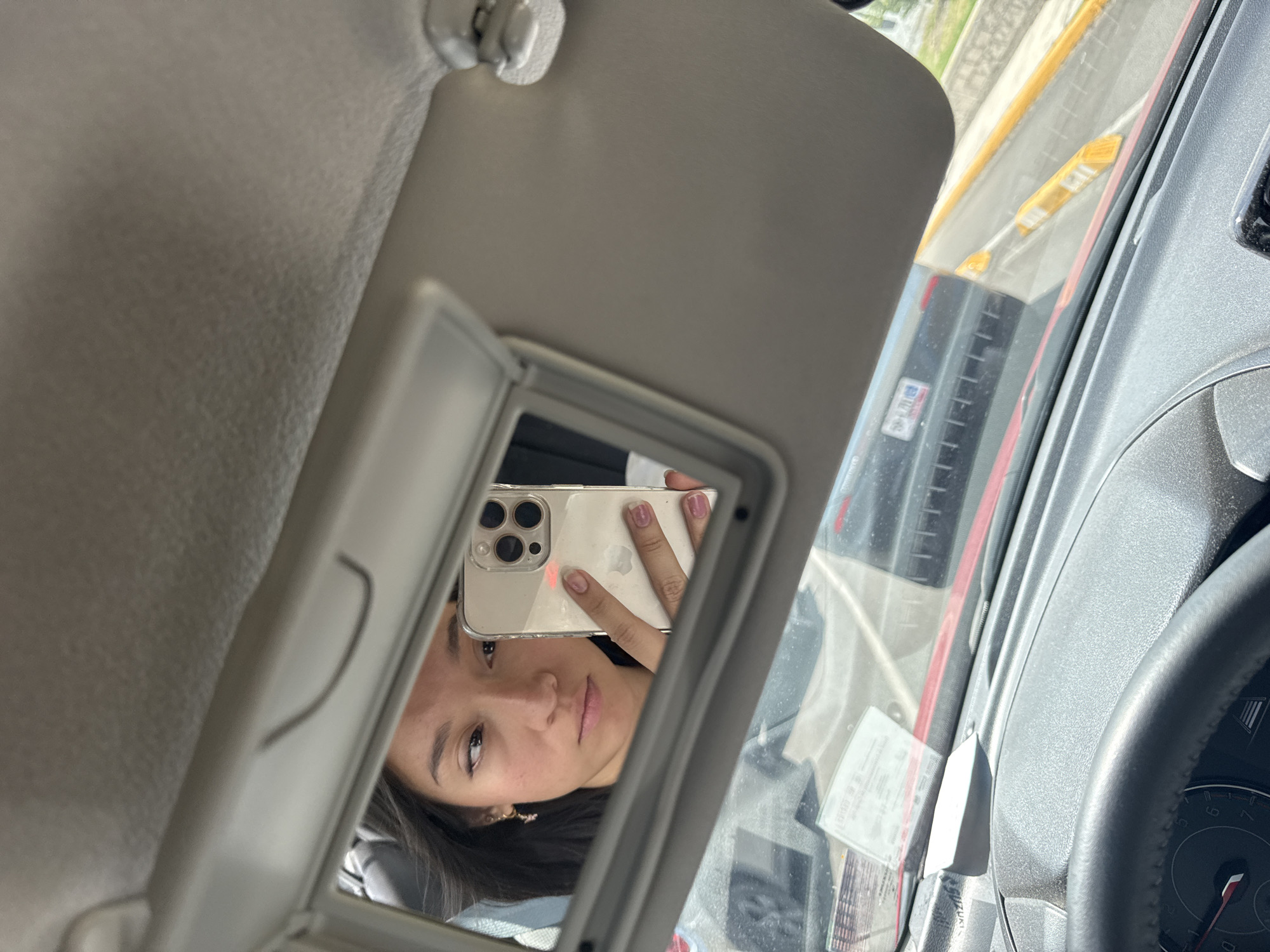 Woman takes selfie in car mirror, Puebla Mexico