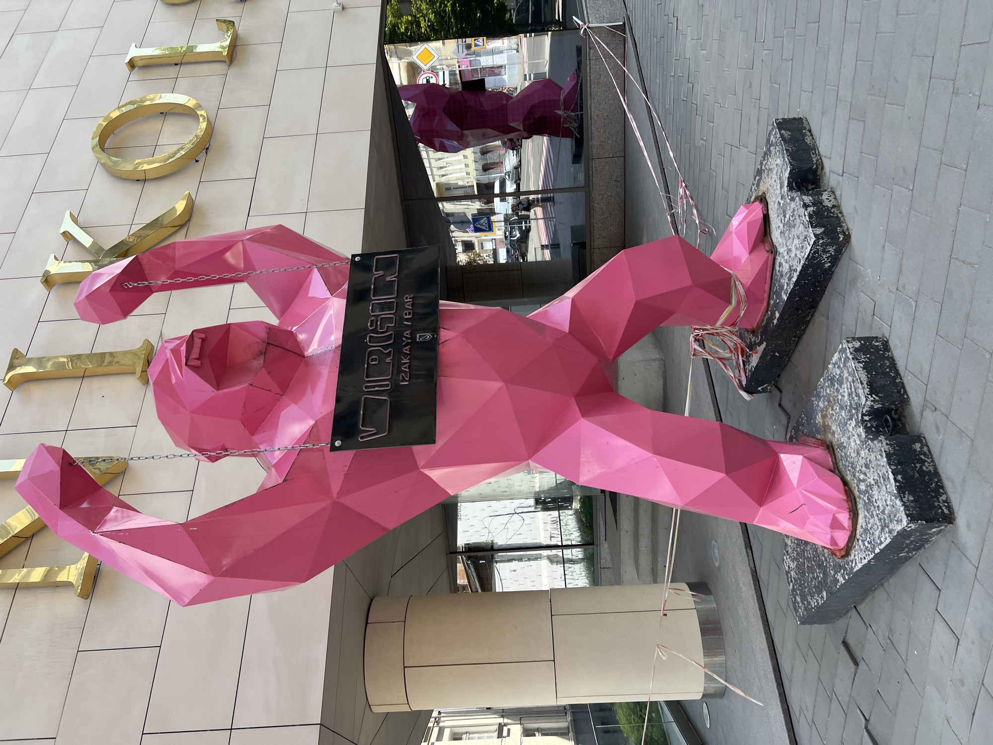 Pink gorilla sculpture outside a Kharkiv street-level building