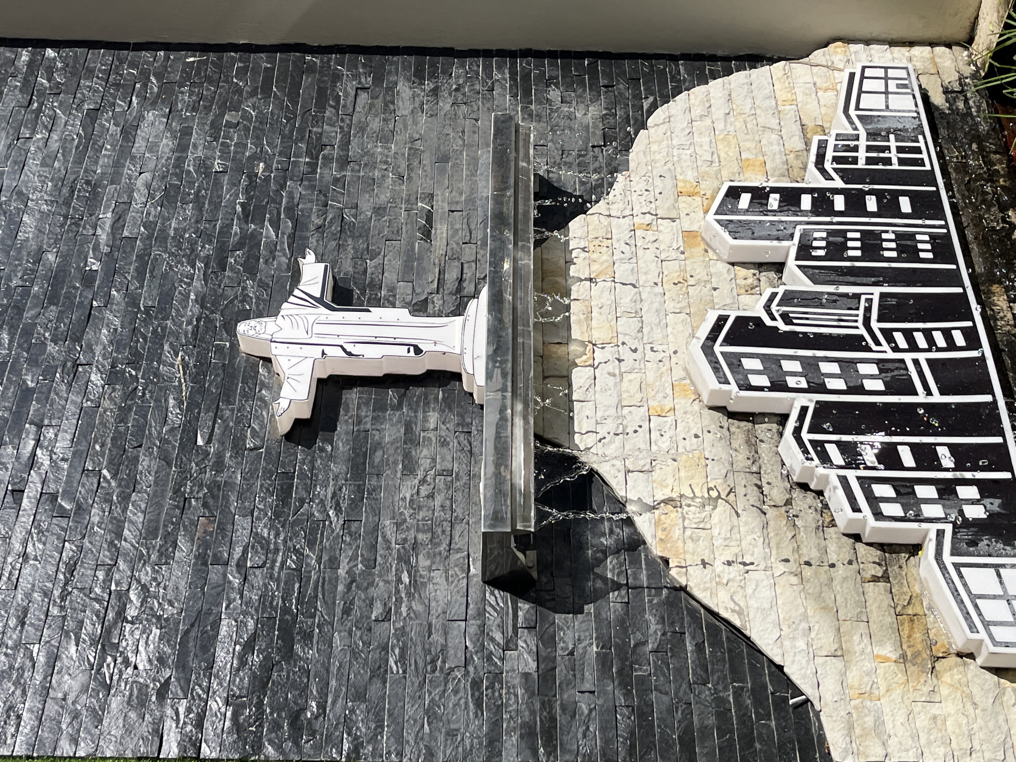 Stone-tiled architectural wall installation observed in urban setting