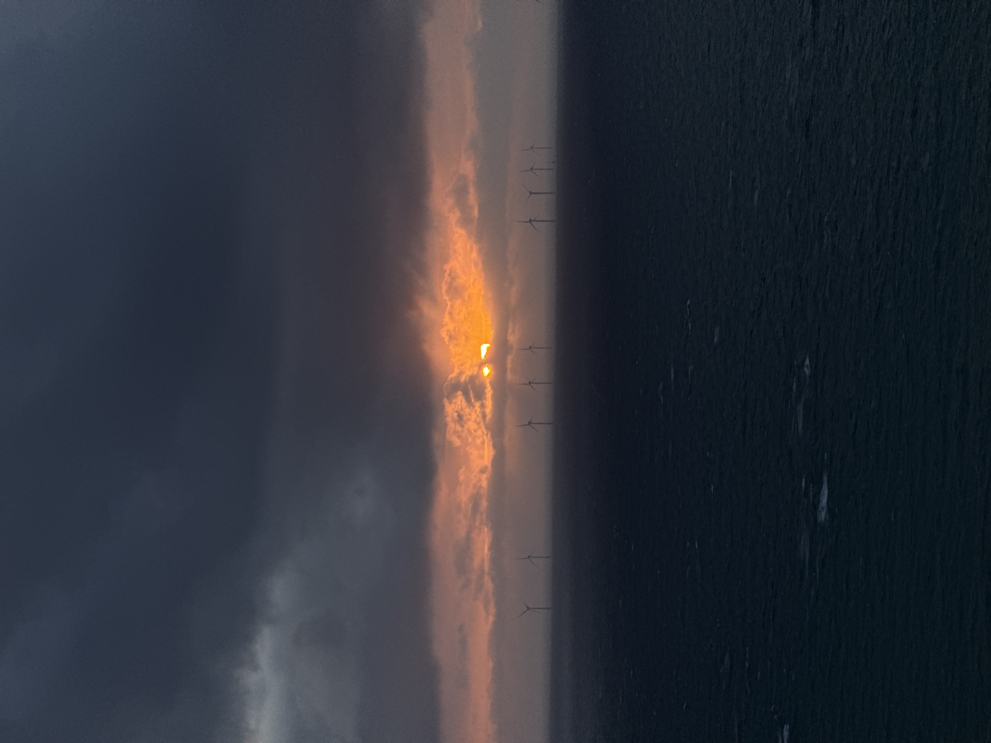 Sunset illuminates offshore wind farm near Fécamp, France