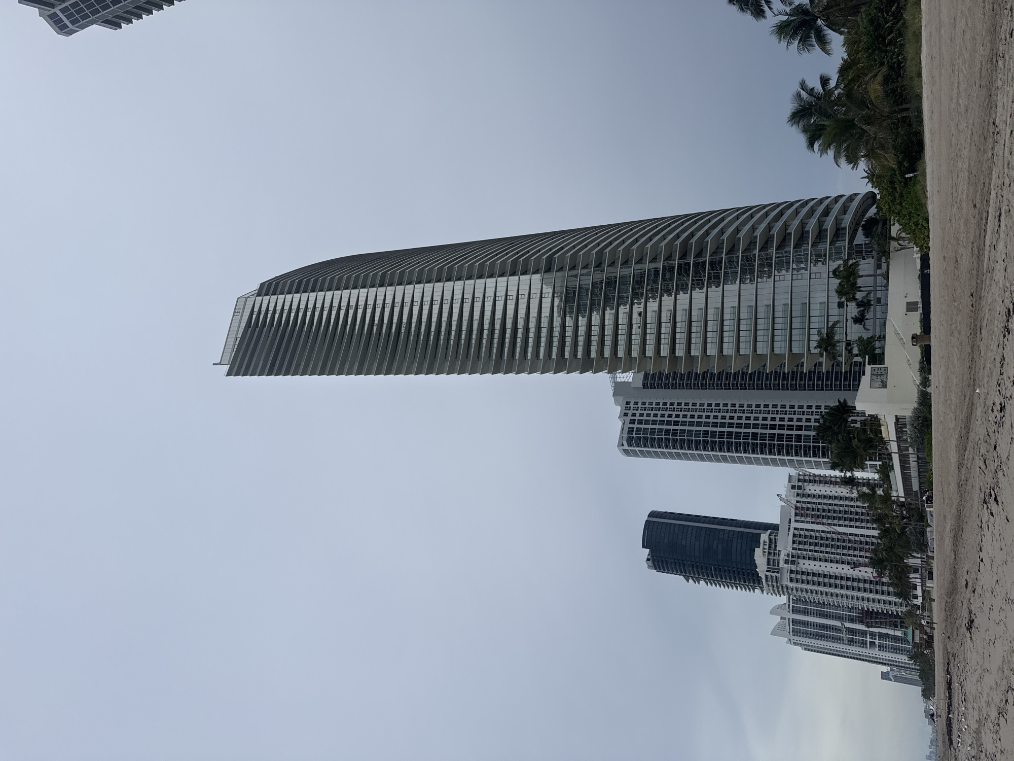 Cloudy afternoon at a high-rise beachfront, city skyline in the background.