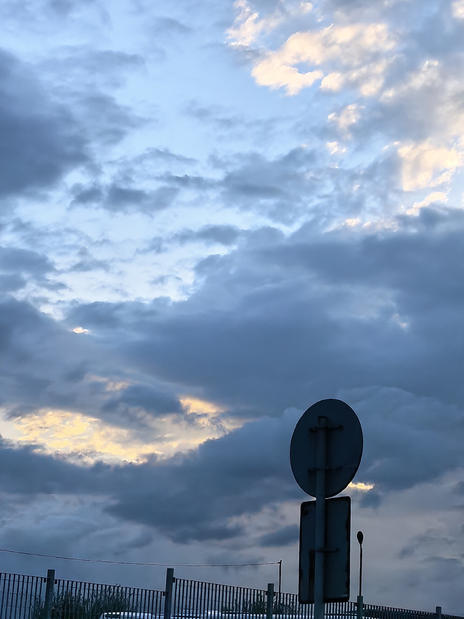 Dawn drive captured through wet streets under dramatic skies