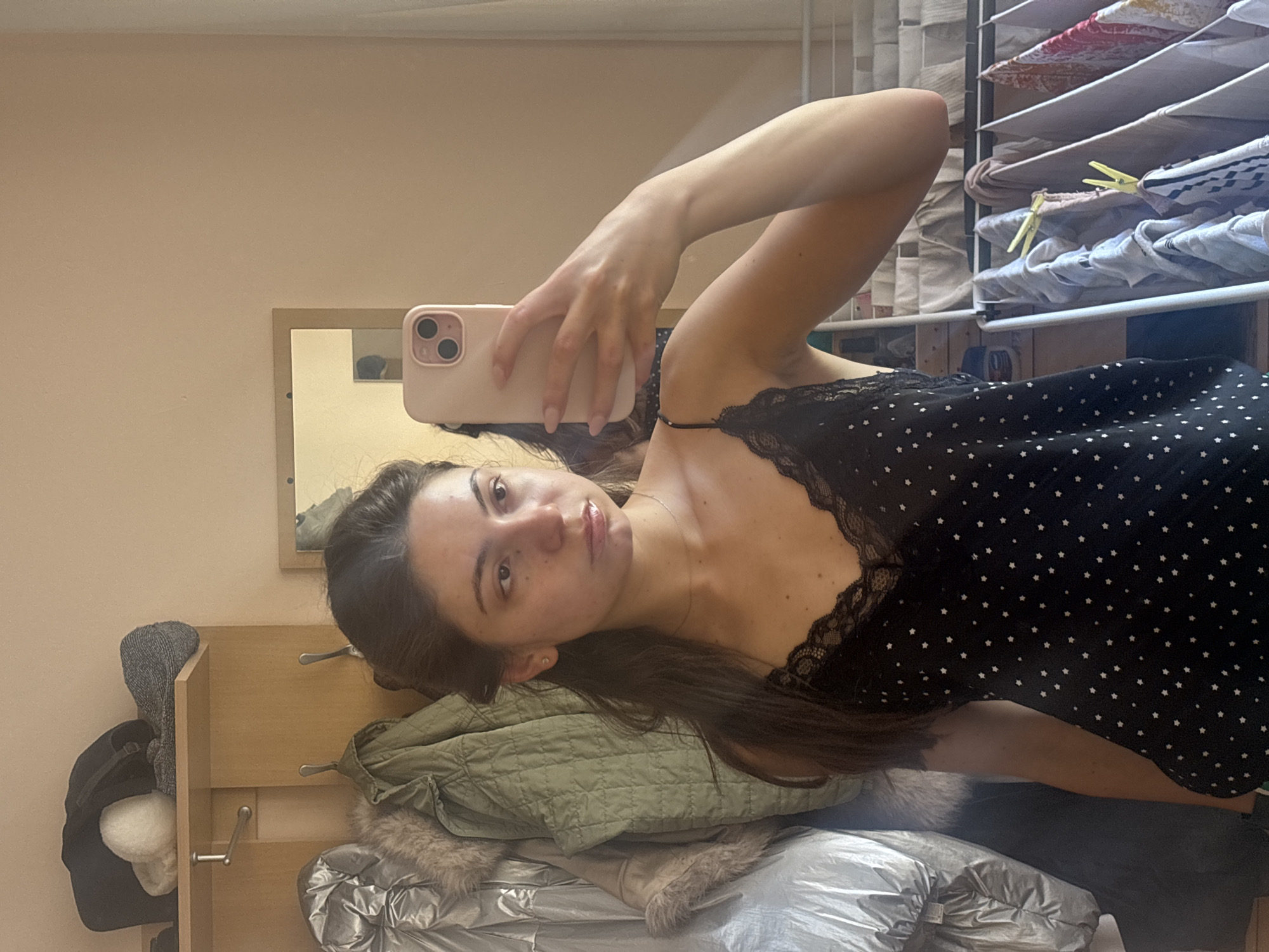 Mirror selfie in a Varna apartment, pink phone in hand.