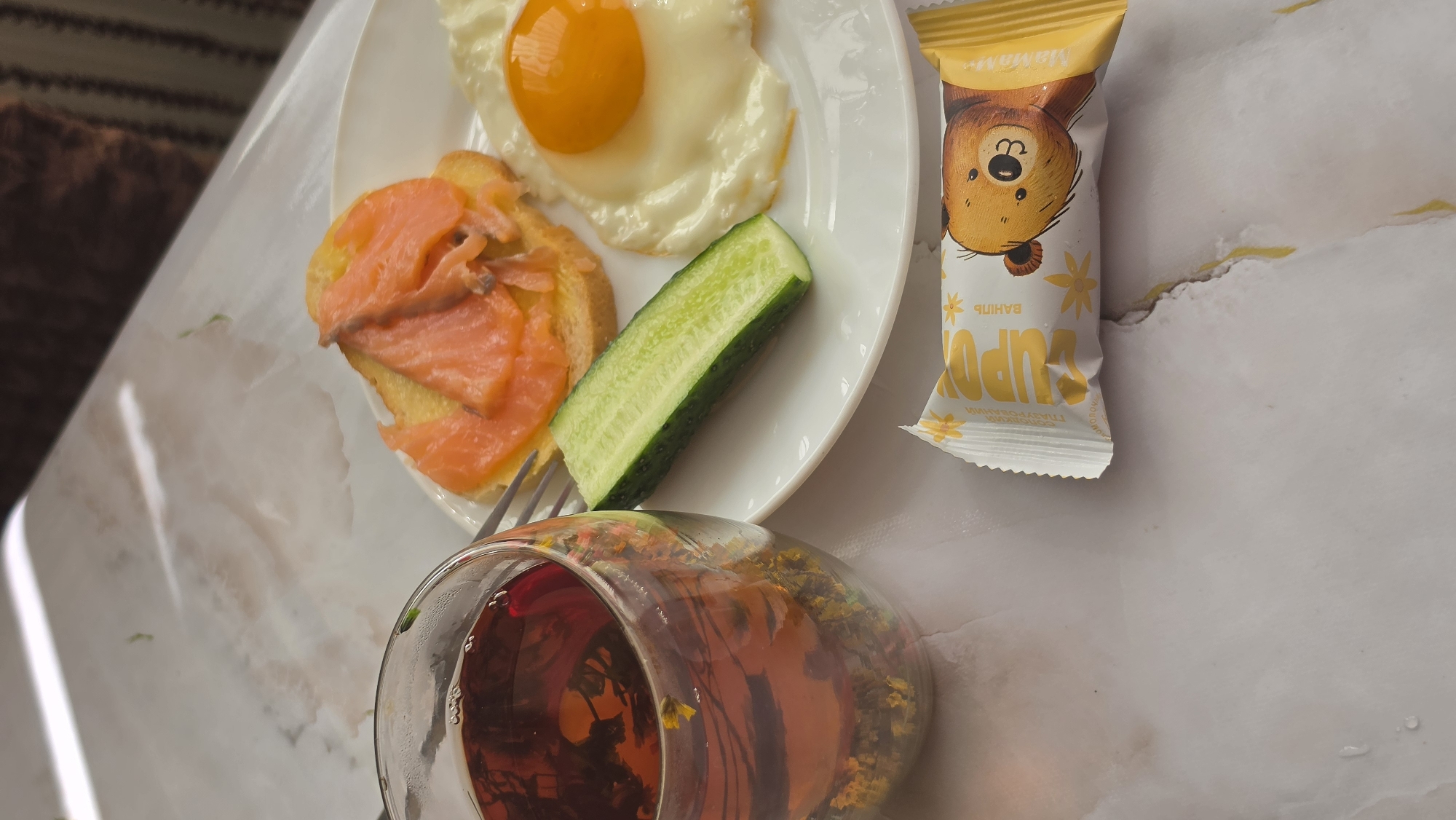 Morning breakfast preparation with decorative coffee and Siamese cat