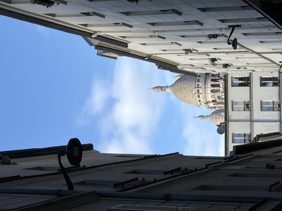 Upward view captured in Parisian alley near Sacré-Cœur