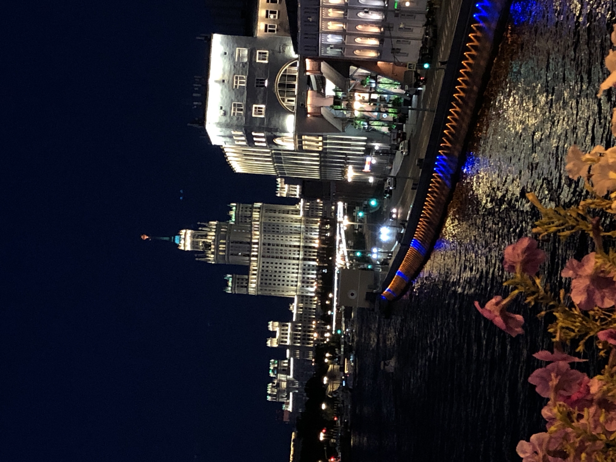 Moscow State University campus glowing at night, reflected in water