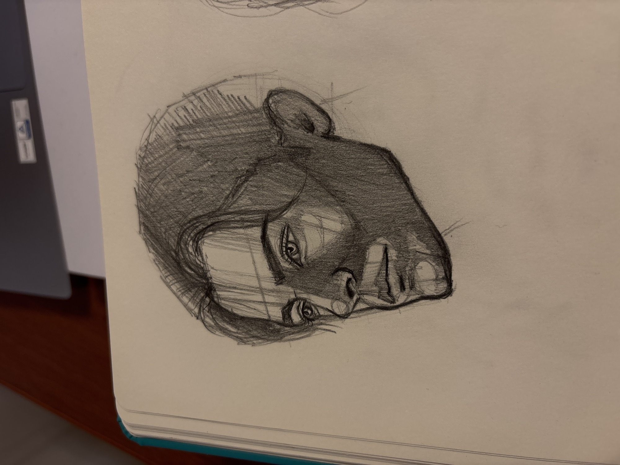 Artist sketches portrait in notebook in Izhevsk