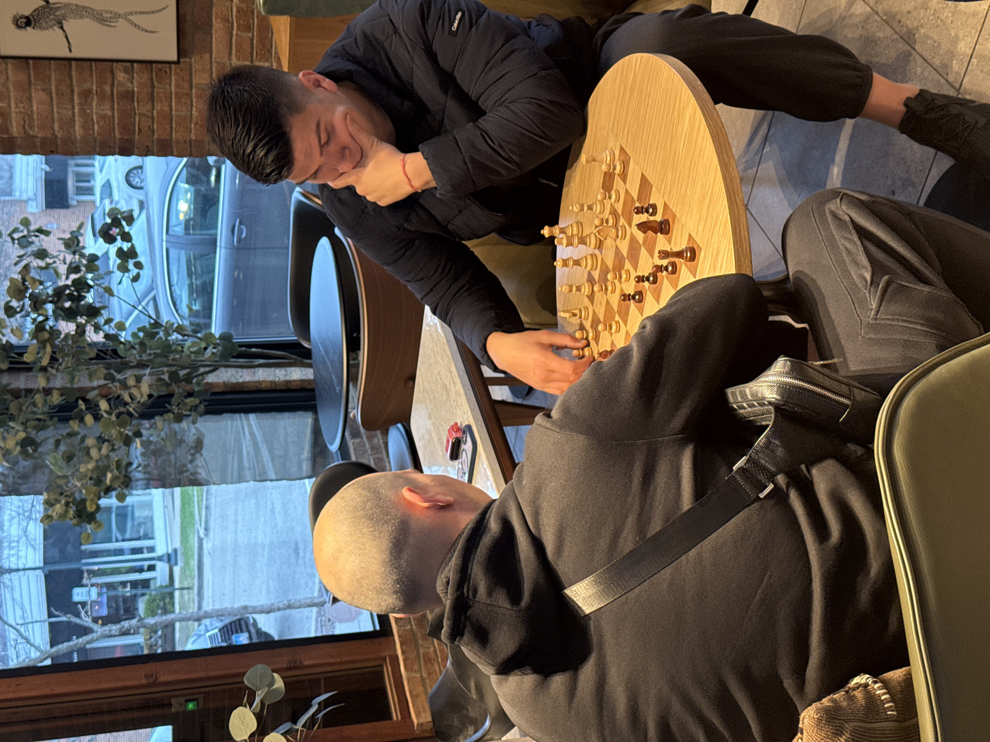 Two men play chess at Winnetka café