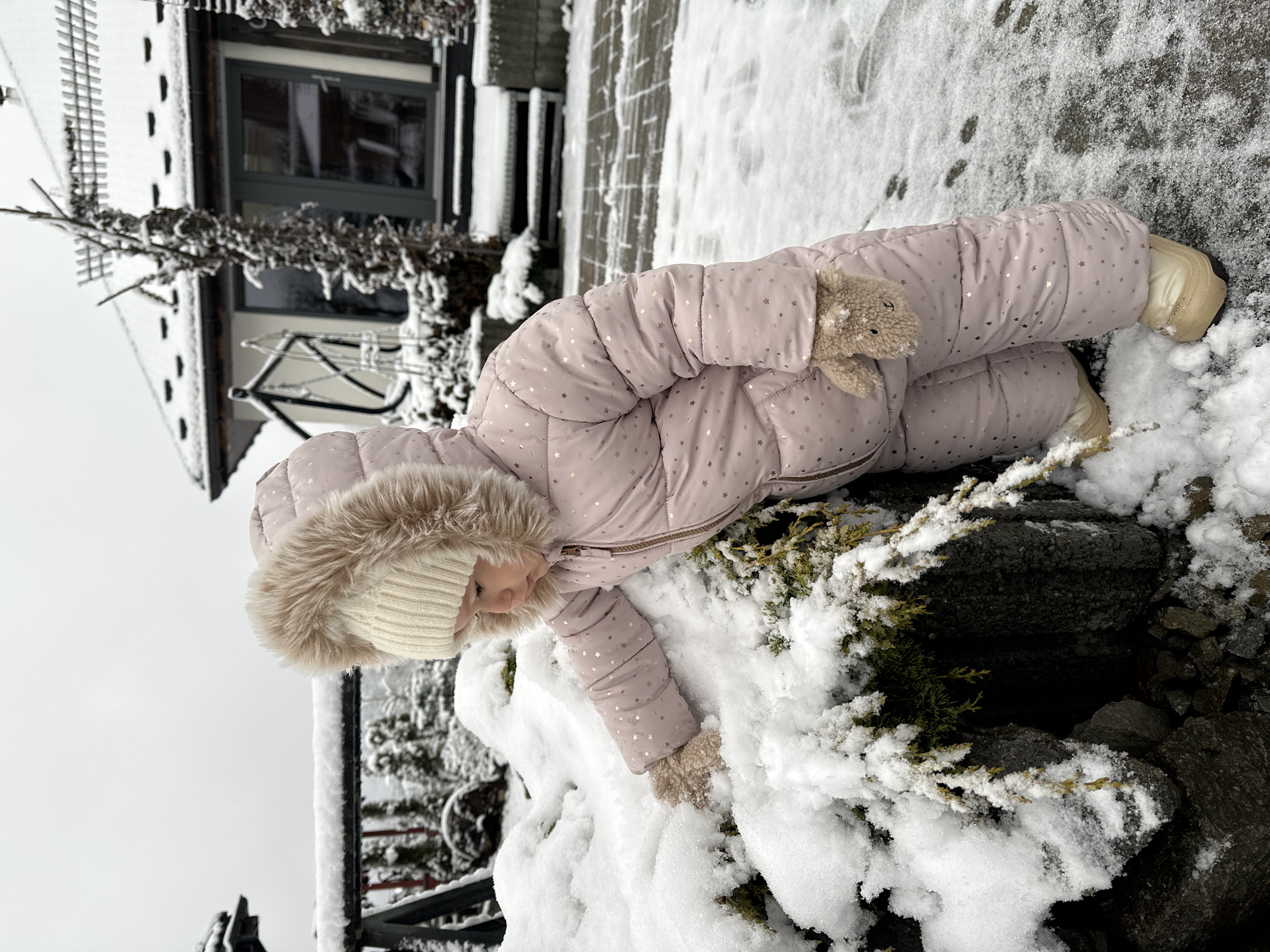 Toddler plays in fresh snow outside Wisła home