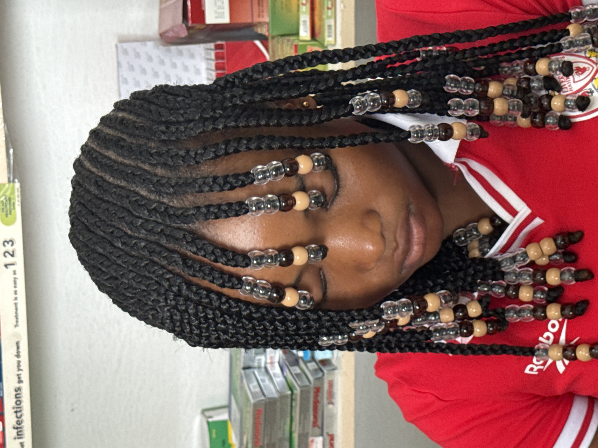 Young woman with beaded braids photographed in Ado, Nigeria