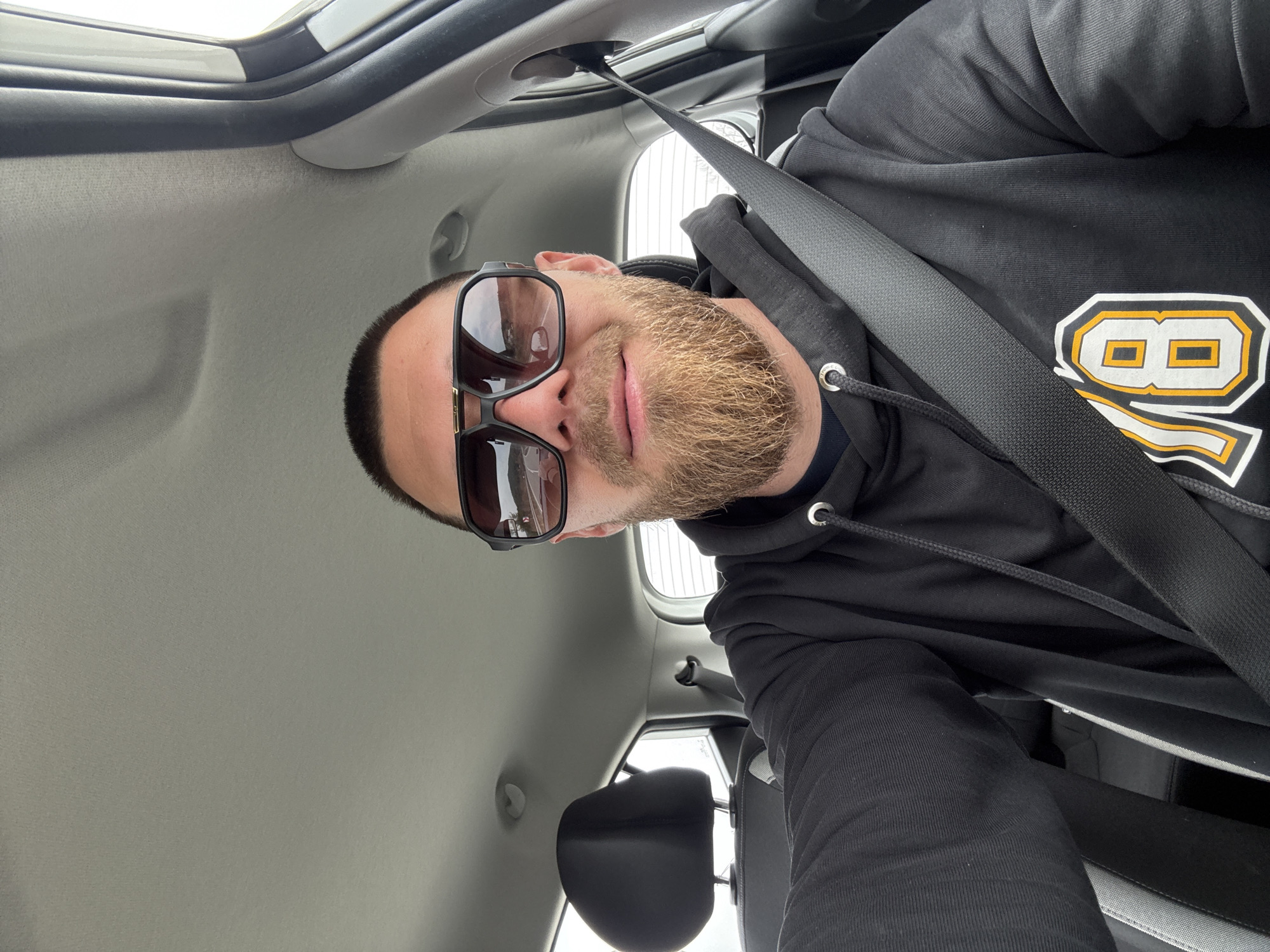 Man in numbered hoodie photographed in car, Bulgaria